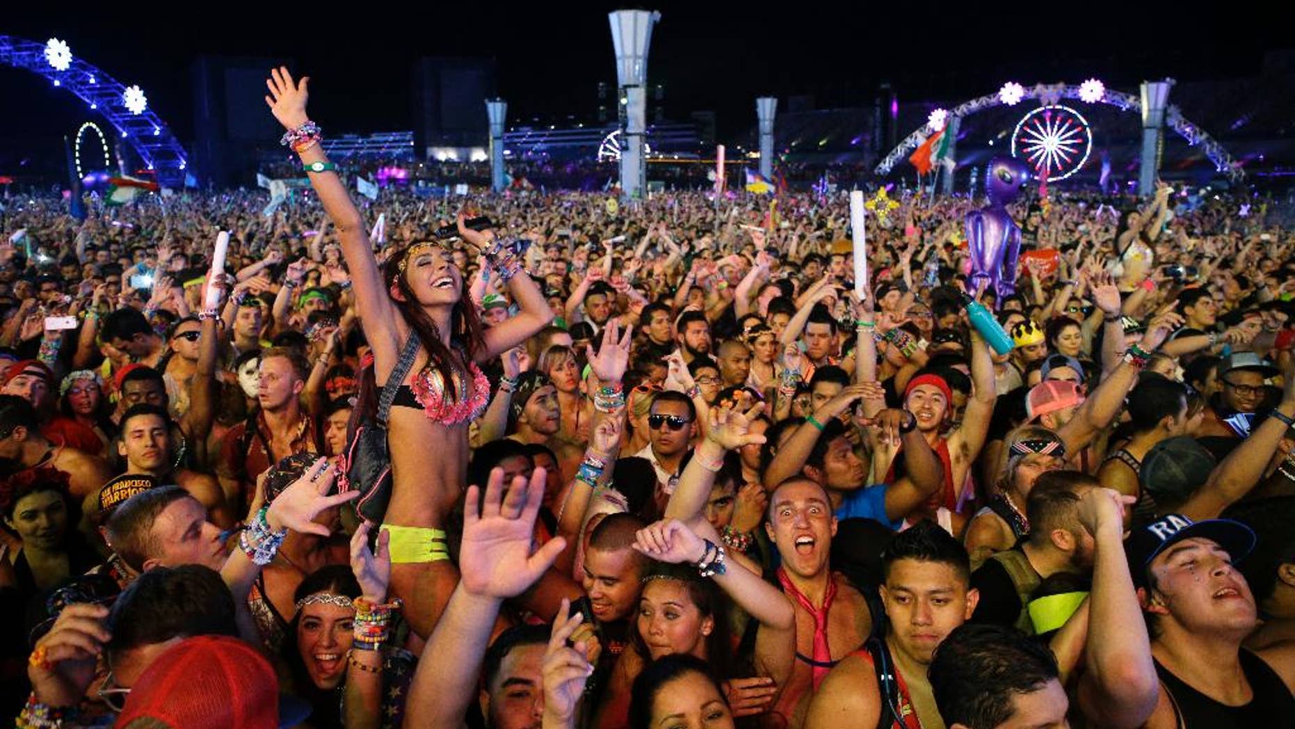 FILE -Carnival goers dance to music by Krewella at the Electric Daisy Carnival in Las Vegas.