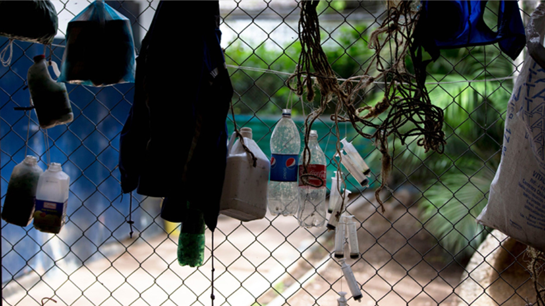 Aug. 26, 2014: Plastic bottles and syringes hang from a fence around a stable at La Rinconada racetrack in Caracas, Venezuela.