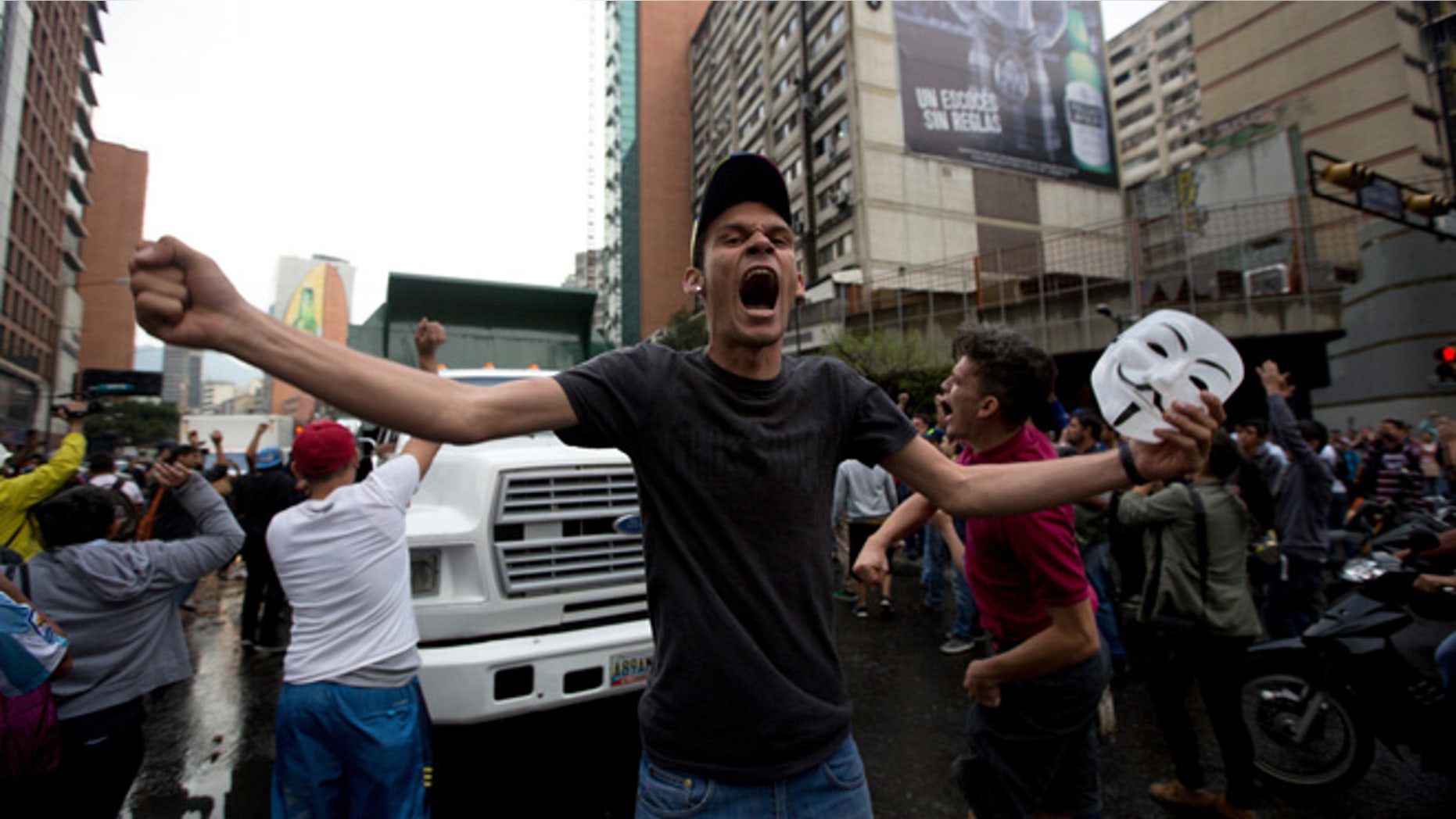 A demonstrator shouts slogans against Venezuela's President Nicolas Maduro as protesters block a road in Caracas, Venezuela, Thursday, Feb. 12, 2015. Venezuelans staged dueling marches to mark the anniversary of last year's bloody protest movement that resulted in more than 40 people being killed, including both government supporters and opponents. Dozens of protesters remain jailed, while the social issues they railed against last year- a faltering economy, widespread shortages and pervasive violent crime - have only gotten worse. (AP Photo/Fernando Llano)