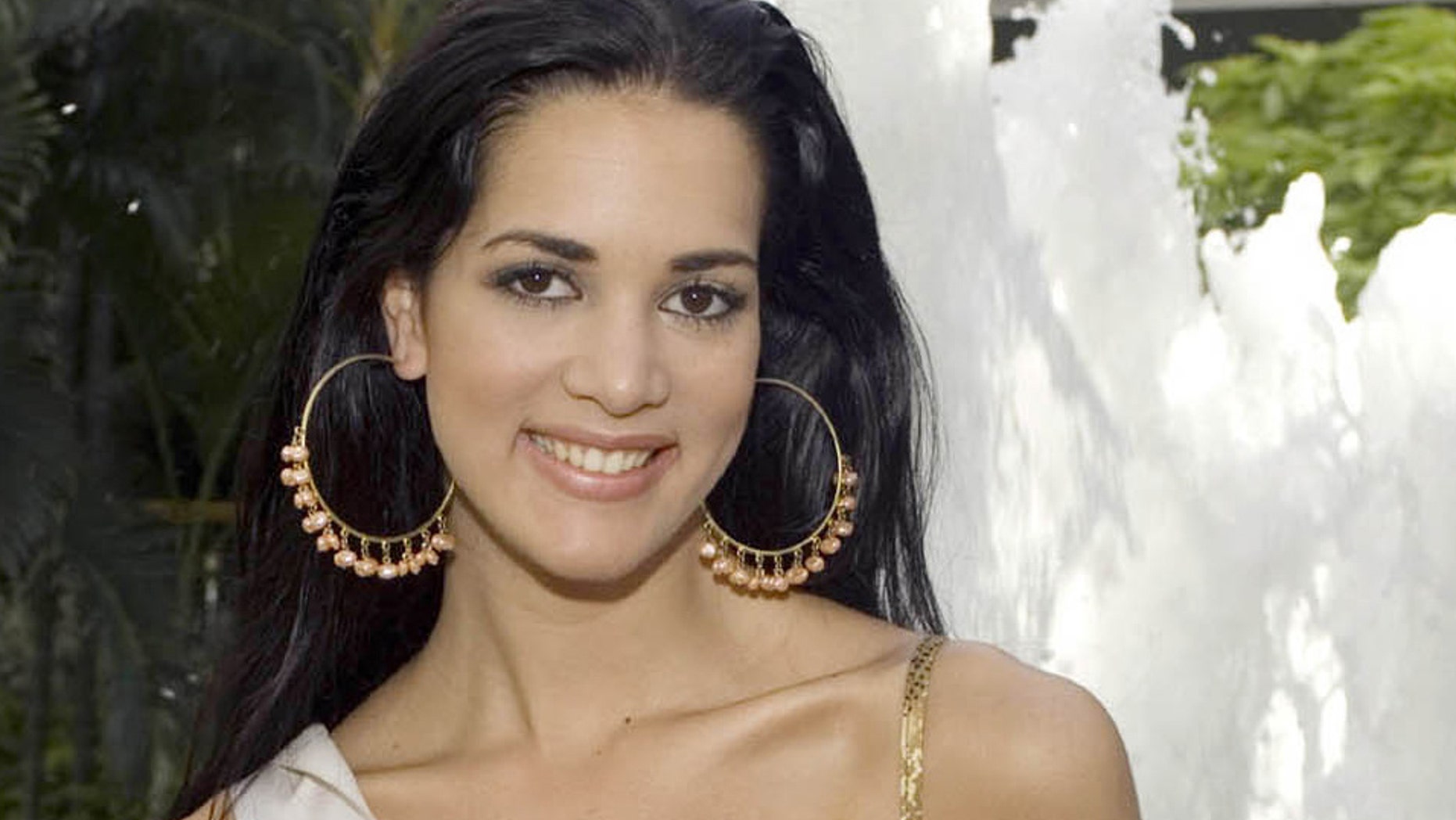 FILE - This May 23, 2005 file photo, released by Miss Universe shows Monica Spear, Miss Venezuela 2005, posing for a portrait ahead of the Miss Universe competition in Bangkok, Thailand. Three men who confessed to murdering the former Miss Venezuela and her husband in a crime that shocked a nation increasingly accustomed to violence have each been sentenced this Tuesday Sept. 23 2014, to more than 20 years in jail. (AP Photo/Miss Universe Darren Decker, File)