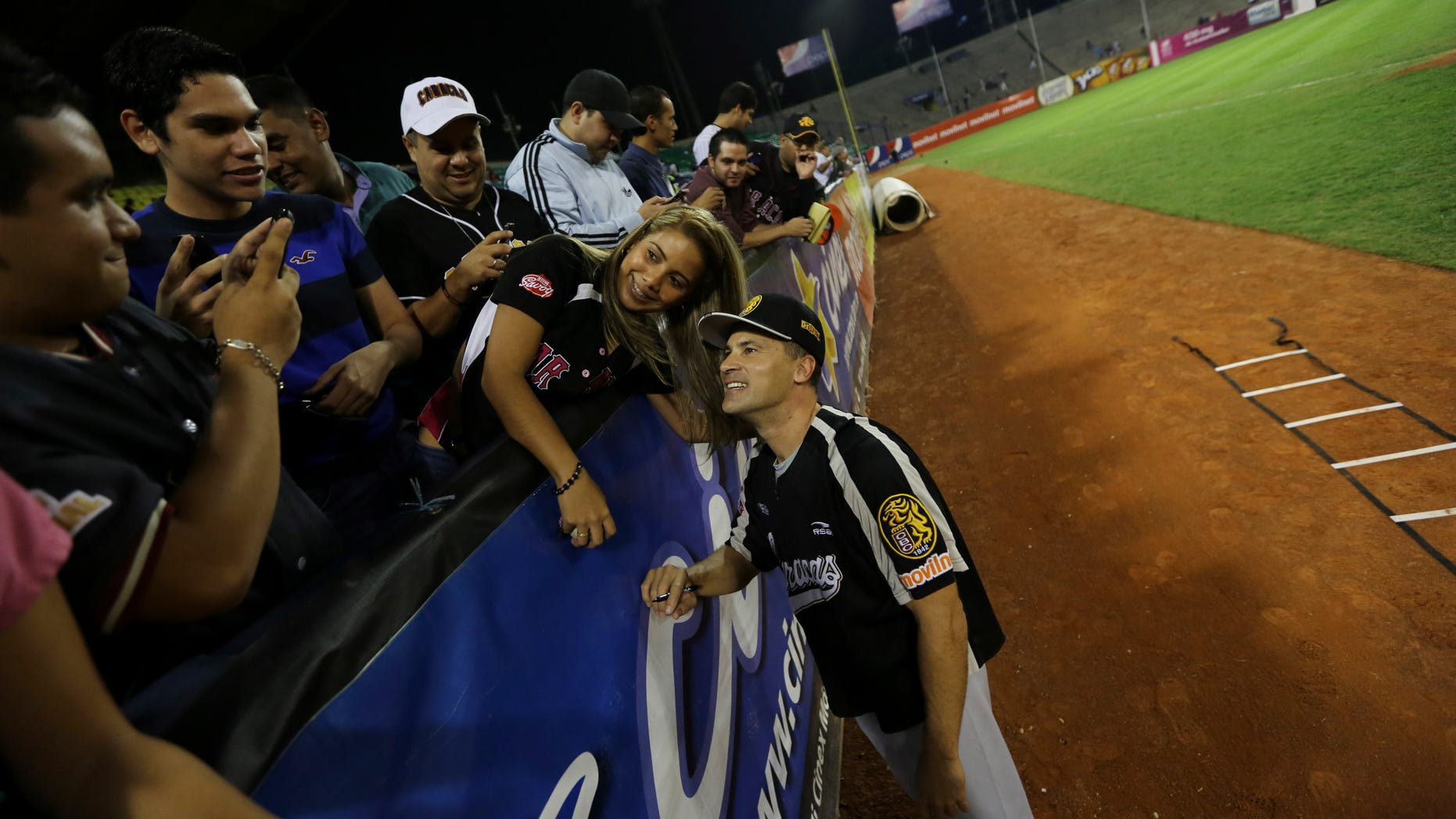 Omar Vizquel, former Cleveland Indians shortstop, poses for a photo with fans on Nov. 27, 2013 in Caracas, Venezuela.