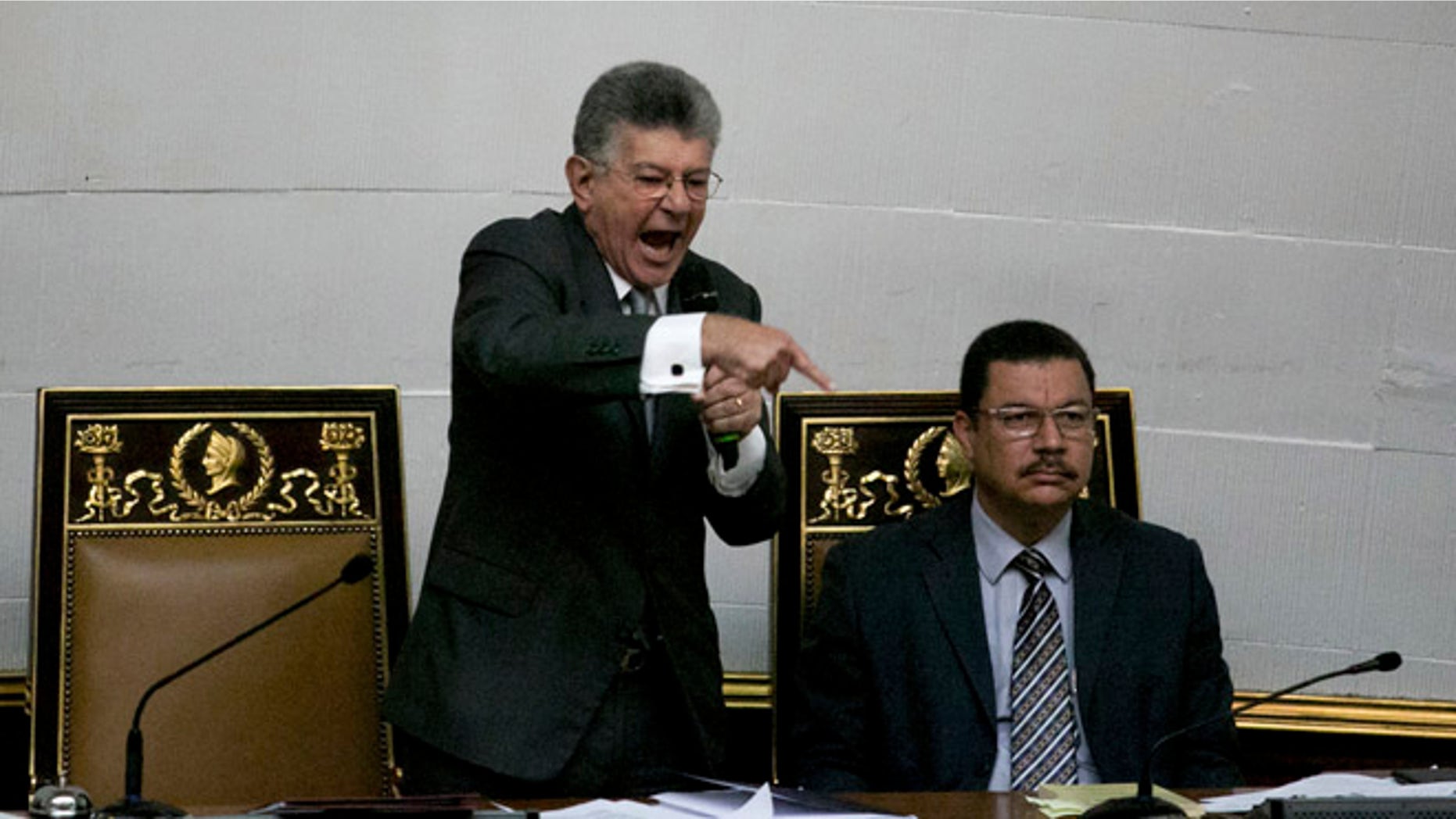 Congressional President Henry Ramos Allup, left center, gives a speech during a special session of Congress in Caracas, Venezuela, Tuesday, Oct. 25, 2016. After the government suspended a recall referendum seeking the president's removal last week, the opposition-controlled congress began debating Venezuelan President Nicolas Maduro's "constitutional situation." Lawmakers vow to present evidence that he's a dual Colombian citizen and therefore constitutionally ineligible to hold Venezuela's highest office. (AP Photo/Alejandro Cegarra)