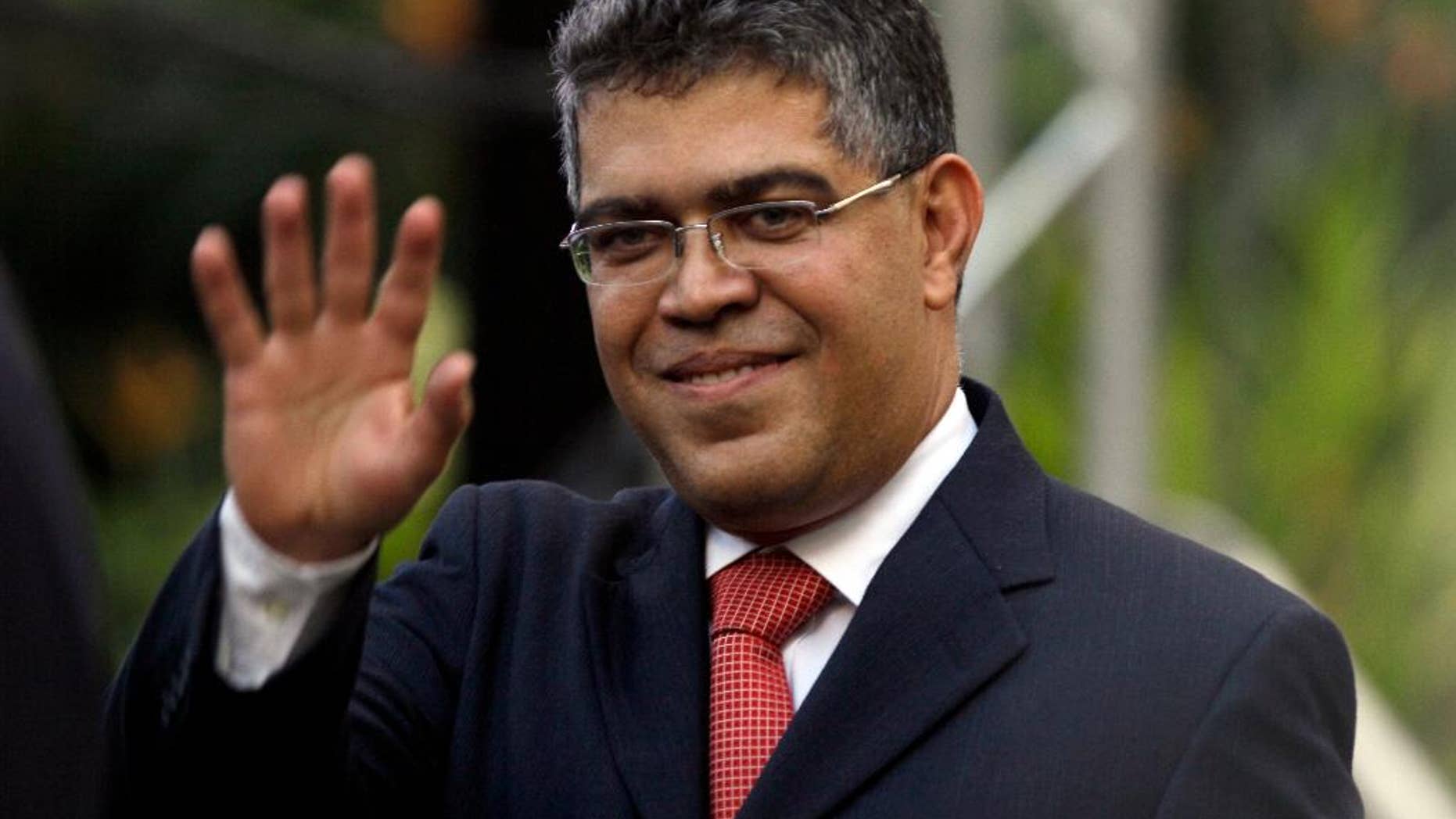 FILE - In this Jan. 15, 2013 file photo, Venezuela's Foreign Minister Elias Jaua waves to supporters after attending the the state-of-the-nation address in Caracas, Venezuela. Brazil is asking the Venezuelan government why it did not provide notification before Jaua met with a Brazilian rural workers organization. (AP Photo/Fernando Llano, File)