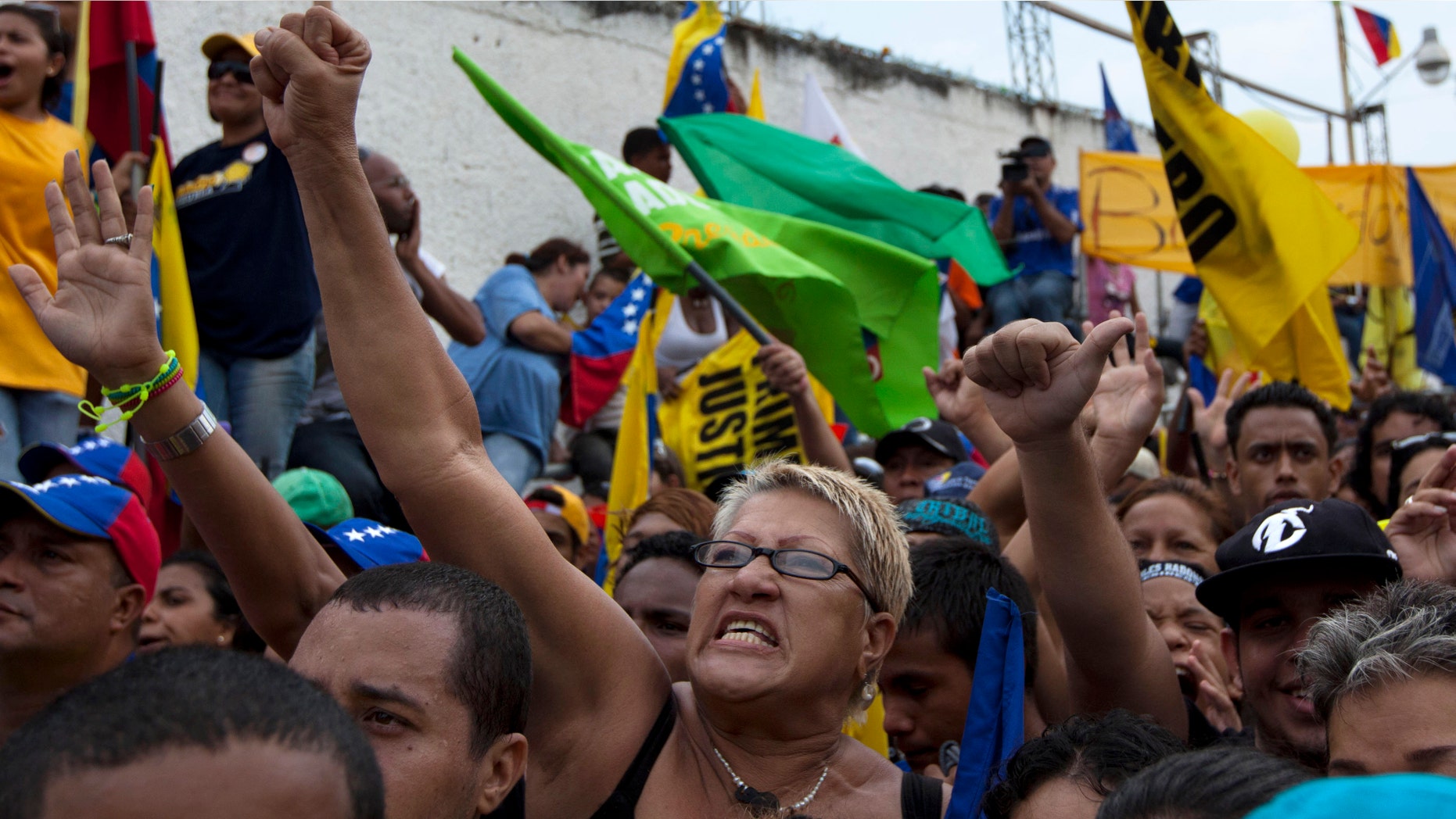 Supporters of opposition presidential candidate Henrique Capriles attend a campaign rally in Puerto Cabello, Venezuela, Wednesday, Sept. 12, 2012. Violence broke out before the opposition campaign event got started, between supporters of Capriles and supporters President Hugo Chavez. Tensions have sporadically erupted into violent clashes and scuffles between supporters of the two candidates ahead of the Oct. 7 presidential vote. (AP Photo/Ariana Cubillos)