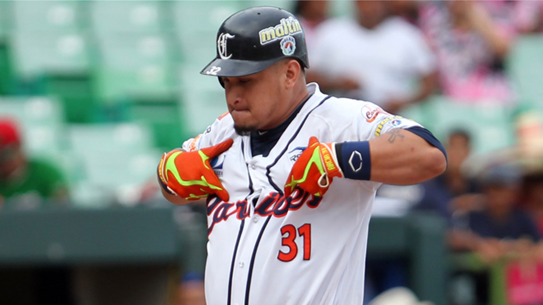 Venezuelas Oswaldo Arcia celebrates at home plate after hitting a home run during a Caribbean Series baseball game against Mexico in San Juan, Puerto Rico, Friday, Feb. 6, 2015. (AP Photo/Ricardo Arduengo)
