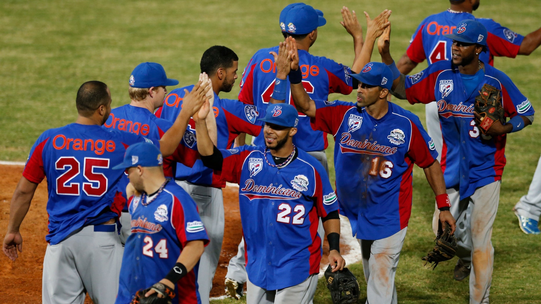 Players of the Dominican Republic celebrate after they defeated Cuba 9-2 during a Caribbean Series game in Porlamar, Venezuela, Feb. 3, 2014.
