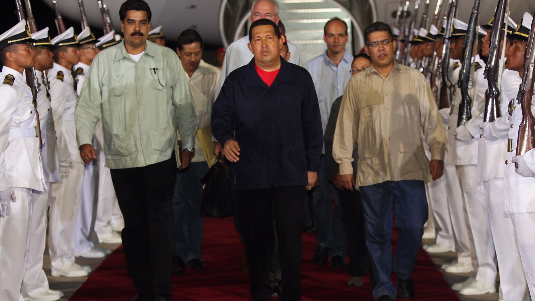 July 23, 2011: In this file photo, released by Miraflores Presidential Press Office, Venezuela's President Hugo Chavez, center, accompanied by Foreign Minister Nicolas Maduro, front left, and Vice President Elias Jaua, front right, arrive to the airport in Maiquetia, Venezuela.