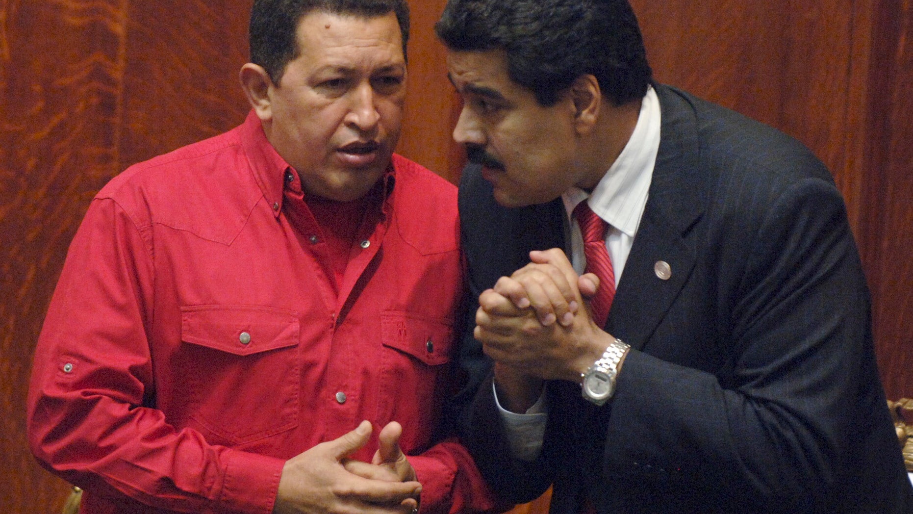FILE - In this Dec. 18, 2007 file photo Venezuela's President Hugo Chavez, left, talks to his Foreign Minister Nicolas Maduro at the University of Uruguay in Montevideo, Uruguay. President Hugo Chavez on Wednesday, Oct. 10, 2012, named Nicolas Maduro as his new vice president. Maduro, a former National Assembly member, has headed the foreign ministry since 2006, and is seen as one of the administration's hard-liners. (AP Photo/Matilde Campodonico, File)