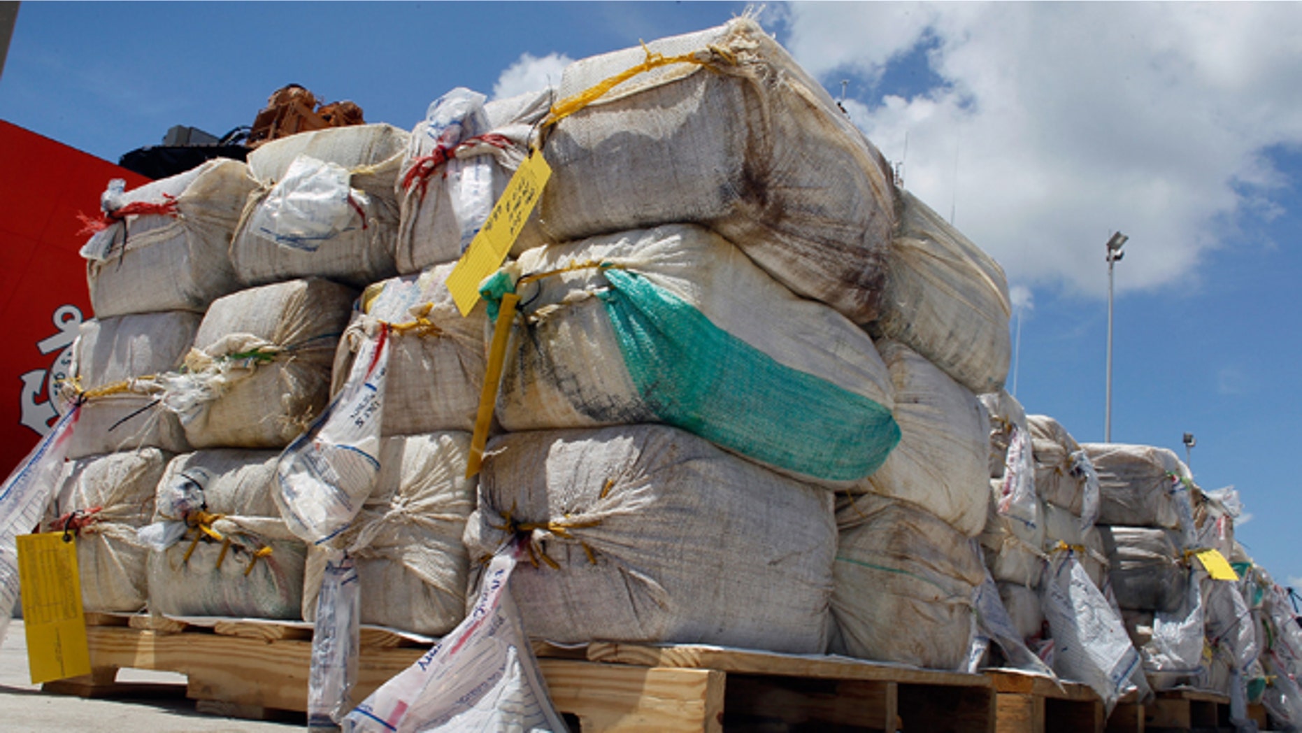 MIAMI BEACH, FL - AUGUST 02: Some of the 15,000 pounds of cocaine that U.S. Coast Guard crew members offloaded from the Cutter Oak are seen next to the ship on August 2, 2011 in Miami Beach, Florida. The cocaine worth more than $180 million was seized from a self-propelled semi-submersible vessel in the western Caribbean Sea on July 13. (Photo by Joe Raedle/Getty Images)