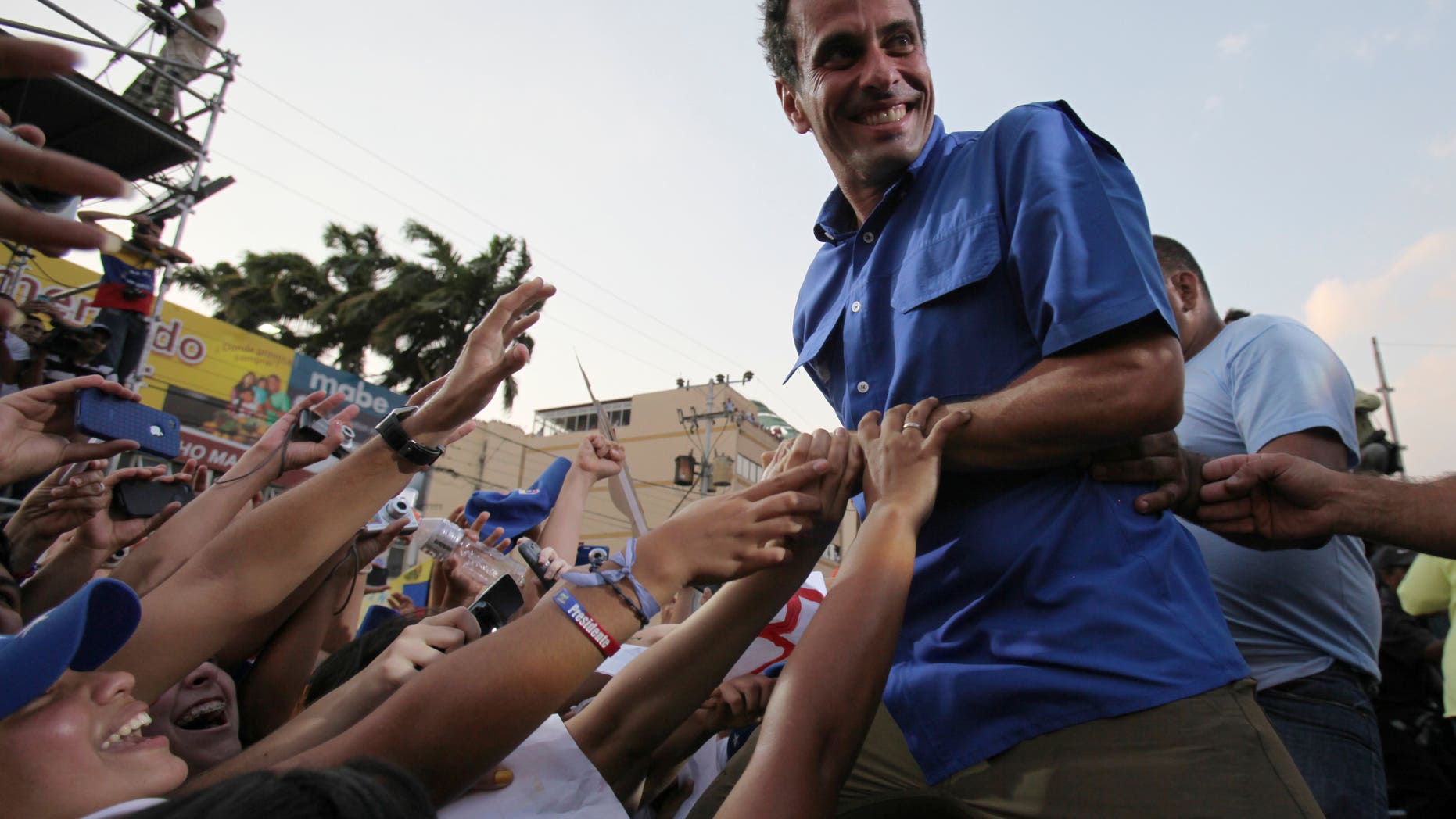 Opposition presidential candidate Henrique Capriles greets supporters during a campaign rally in Puerto La Cruz, Venezuela, April 8, 2013.