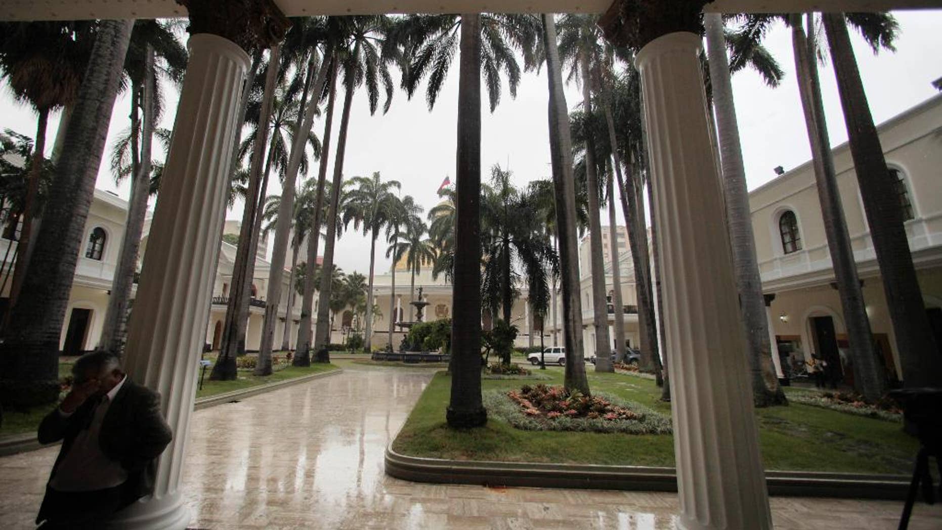 FILE - In this July 31, 2009, file photo, a lawmaker takes a break in the garden area outside the National Assembly chamber in Caracas, Venezuela. Venezuelan election officials have set a date for 2015 parliamentary elections after months of growing pressure from local opposition groups and international observers. Elections council head Tibisay Lucena announced Monday, June 22, 2015 that the South American country will hold National Assembly elections on December 6. (AP Photo/Fernando Llano, File)
