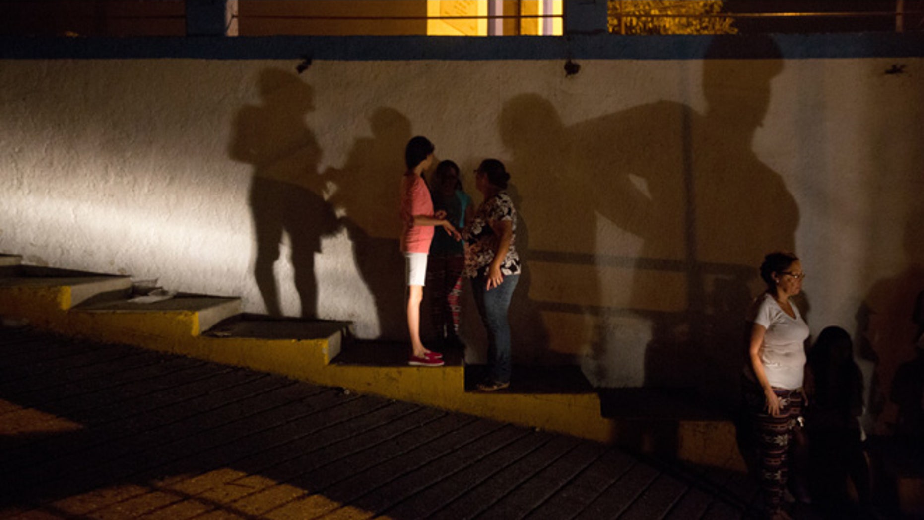 In this Saturday, April 23, 2016 photo, residents make their way to a protest against energy rationing after going through a 24-hour blackout, in the El Calvario neighborhood of El Hatillo, just outside of Caracas, Venezuela. Energy rationing has been added to the hardships faced by Venezuelans overwhelmed by inflation, shortages of food and medicine and rising crime. (AP Photo/Fernando Llano)
