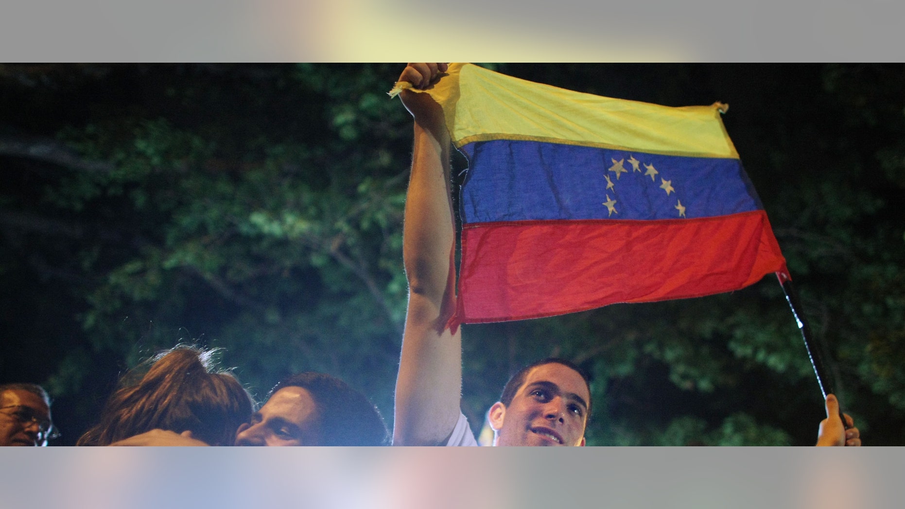 CARACAS, VENEZUELA - DECEMBER 03: Opposition supporters celebrate after defeating a referendum on changes to the Constitution proposed by Venezuelan President Hugo Chavez December 3, 2007 in Caracas, Venezuela. The tightly contested referendum proposed an elimination of term limits for Chavez and a transformation of Venezuela into a "socialist economy." Voters defeated the measures by a vote of 51 percent to 49 percent. (Photo by Mario Tama/Getty Images)