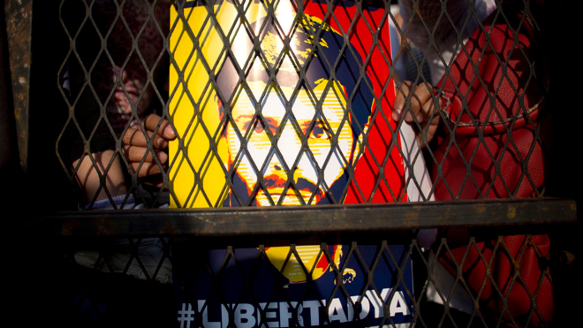 FILE - In this Feb. 20, 2016 file photo, supporters of Venezuela's jailed opposition leader Leopoldo Lopez hold posters of him during a protest demanding the release of Lopez and other jailed opposition leaders, on the second anniversary of his imprisonment, in Caracas, Venezuela. Spain's former Prime Minister Jose Luis Rodriguez Zapatero had a surprise jailhouse meeting with Lopez on June 4, 2016. It's the first time an outside visitor besides Lopez's family or lawyers have met with Lopez in the military prison where he's been held for over two years. (AP Photo/Ariana Cubillos, File)