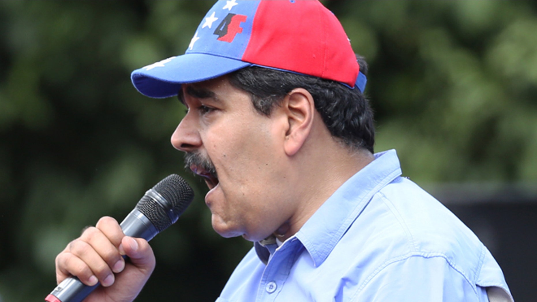 Venezuelas President Nicolas Maduro speaks to supporters during a rally to commemorate the end of Marcos Perez Jimenez's dictatorship 57 years ago, in Caracas, Venezuela, Friday, Jan. 23, 2015. President Maduro spoke against the planned visit by the ex-presidents, Andres Pastrana of Colombia, Felipe Calderon of Mexico and Sebastian Pinera of Chile, saying that the three men are coming to Venezuela to support a right wing coup against the government. (AP Photo/Ariana Cubillos)