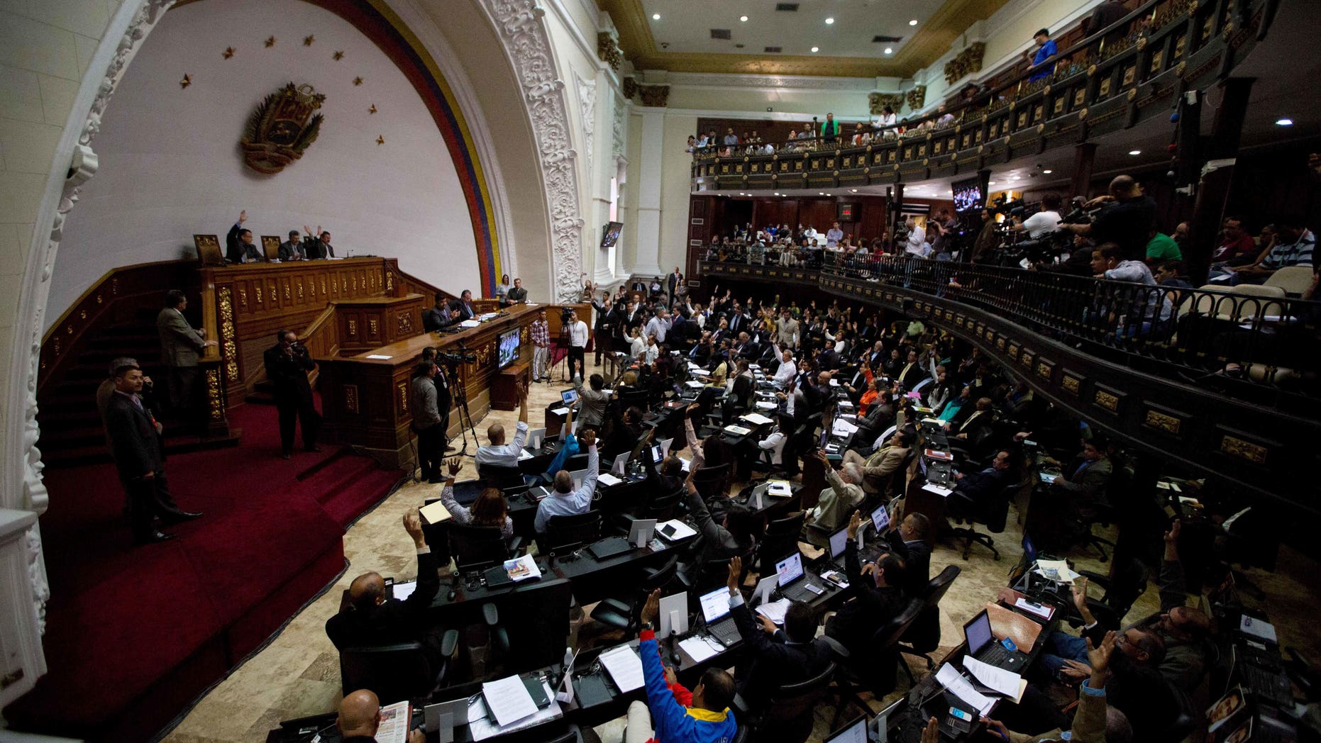 Venezuelan National Assembly lawmakers vote during a session on Jan. 14, 2016 in Caracas, Venezuela.