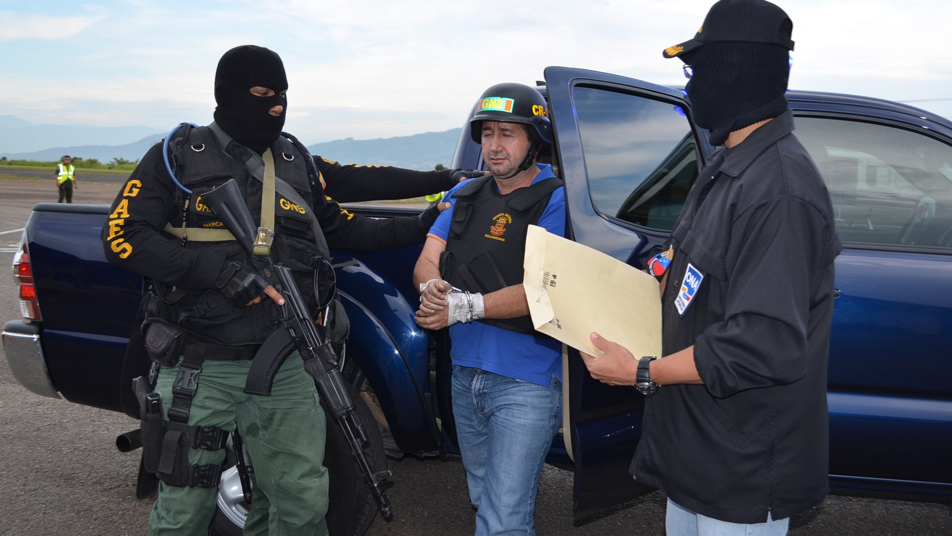 Sept. 19, 2012: Venezuela's judicial police officers escort alleged Colombian drug trafficker Daniel Barrera, center, at the Regional Command No. 1 National Guard base in San Cristobal, Tachira state, Venezuela.
