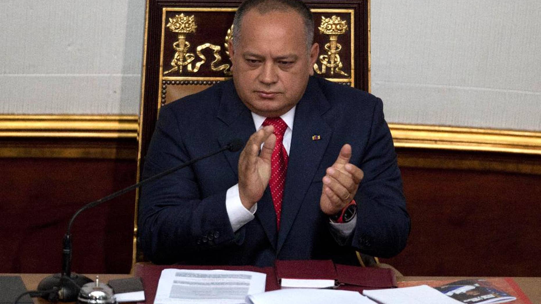 FILE - In this Jan. 5, 2013 file photo, National Assembly President Diosdado Cabello applauds before addressing the National Assembly in Caracas, Venezuela. Cabello said on Wednesday, May 13, 2015 he is asking courts to bar news executives from leaving the country while he’s suing them for alleged defamation. (AP Photo/Ariana Cubillos, File)