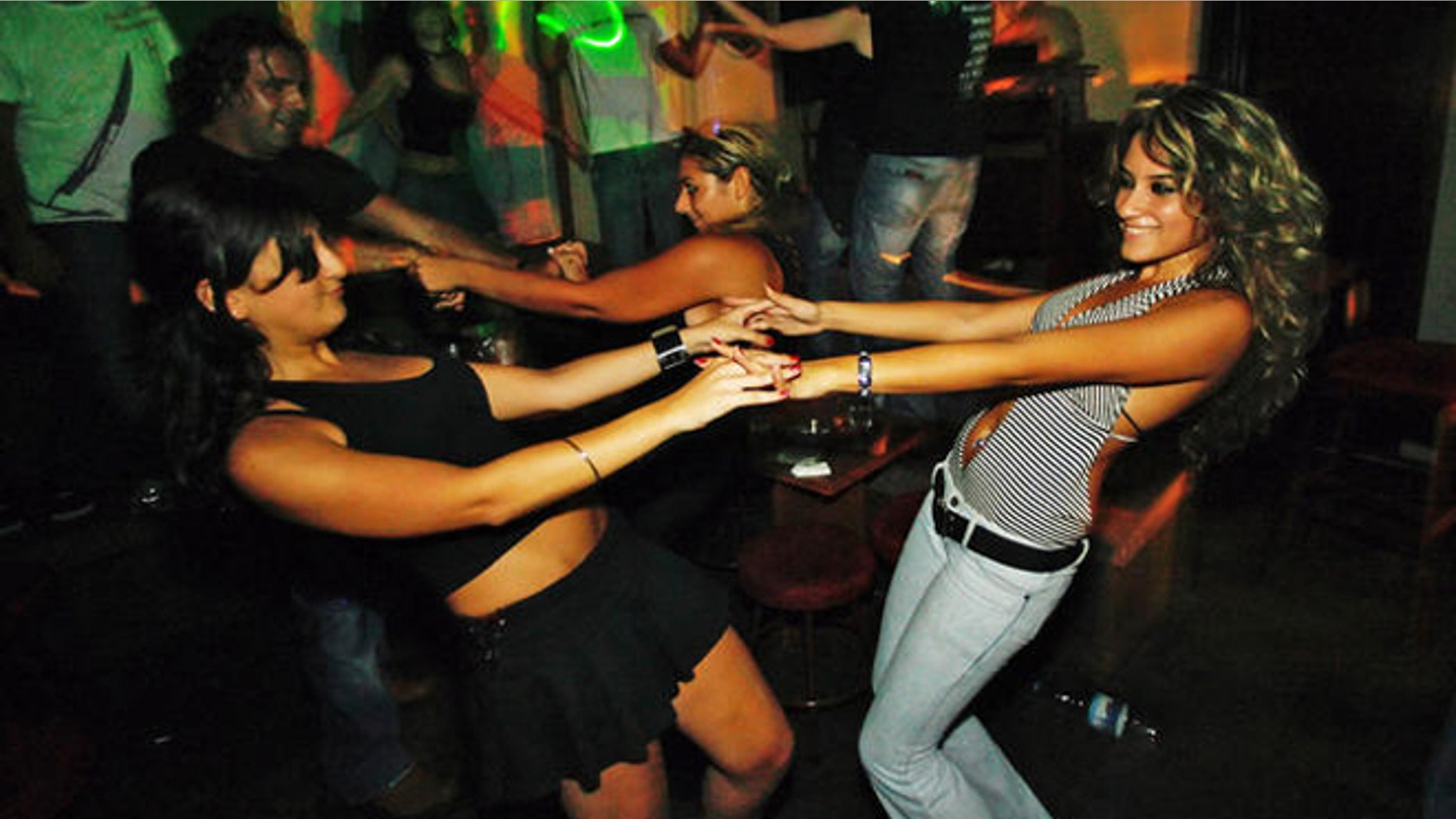 Lebanese women dance in the BOA bar at Monot Street in the Christian heartland of Ashrafieh, an area of Beirut, Lebanon, late Saturday, Aug. 19, 2006. On the sixth day of the UN-brokered cease-fire the Lebanese capital was returning to normal as bars, nightclubs, and restaurants came back to life after 34-day-long fighting between the Israel and Hezbollah guerrillas. (AP Photo/Kevork Djansezian)
