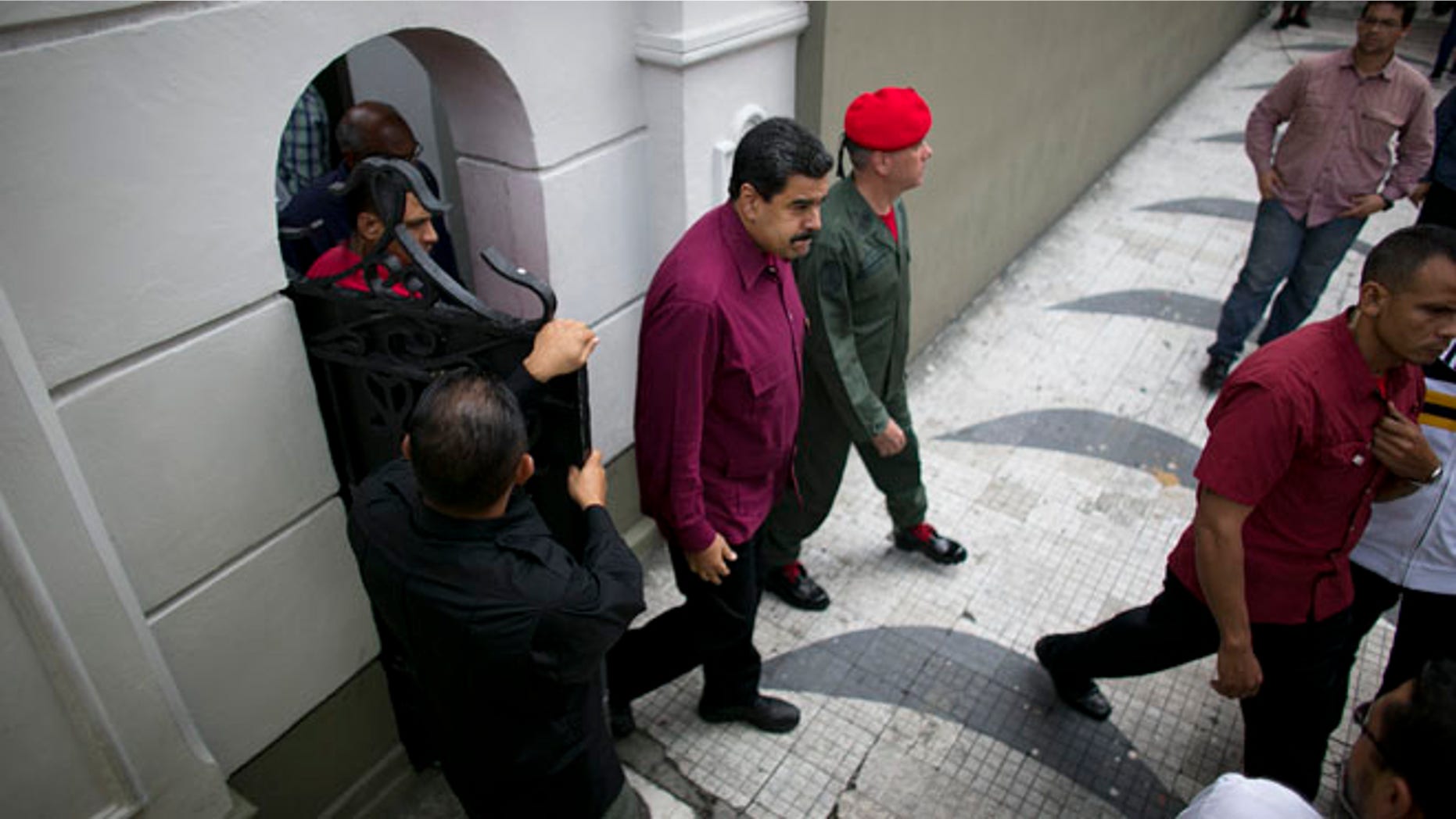 President Maduro exits an area of Miraflores presidential palace in Caracas, Venezuela, Friday, Oct. 28, 2016.