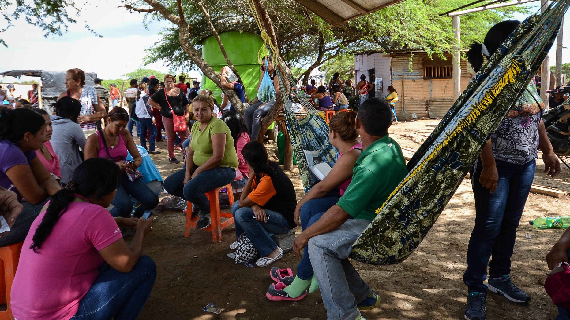 Relative of inmates wait for information outside the Viloria prison in Barquisimeto, Venezuela, Nov. 27, 2014.