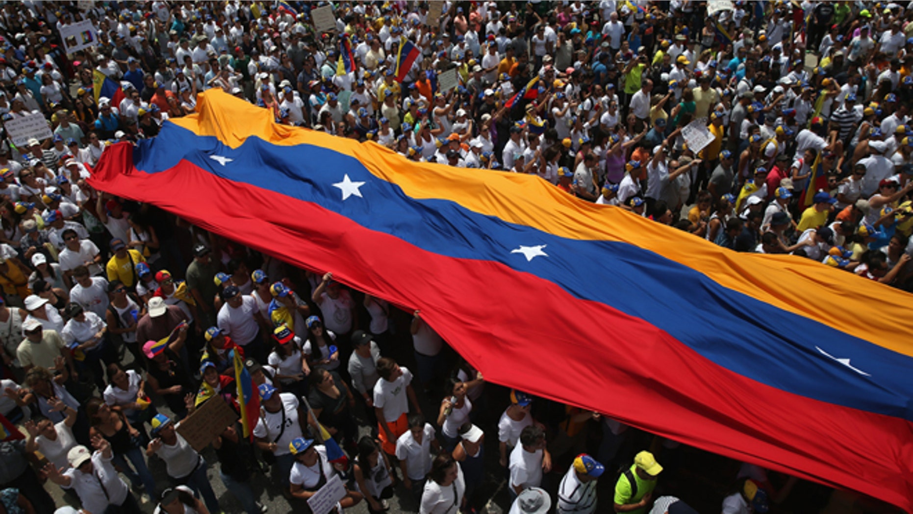 CARACAS, VENEZUELA - MARCH 02: Thousands of protesters march in one of the largest anti-government demonstrations yet on March 2, 2014 in Caracas, Venezuela. Venezuela has one of the highest inflation rates in the world, and opposition supporters have protested for almost three weeks, virtually paralyzing business in much of the country. (Photo by John Moore/Getty Images)