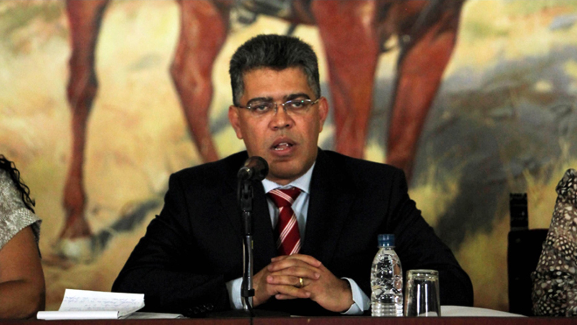 Venezuela's Foreign Minister Elias Jaua speaks during a ceremony to honor two Venezuelan diplomats expelled from Washington after Venezuela kicked out two U.S. military attaches, for allegedly conspiring against its government, in Caracas, Venezuela, Wednesday, March 20, 2013. Jaua said Venezuela has cut off all diplomatic contact with the United States, saying Washington is meddling in its domestic affairs. Behind is a painting of independence hero Simon Bolivar. (AP Photo/Fernando Llano)