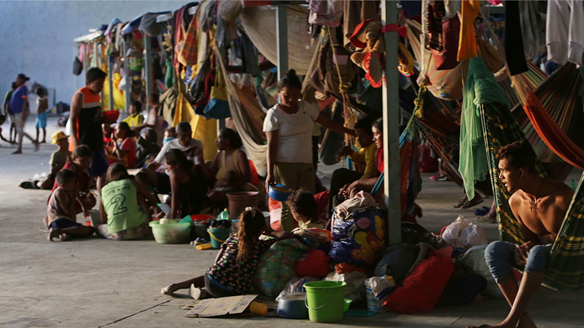 Indigenous Warao refugees from Venezuela sit on the floor at a shelter in Pacaraima, Roraima state, Brazil.