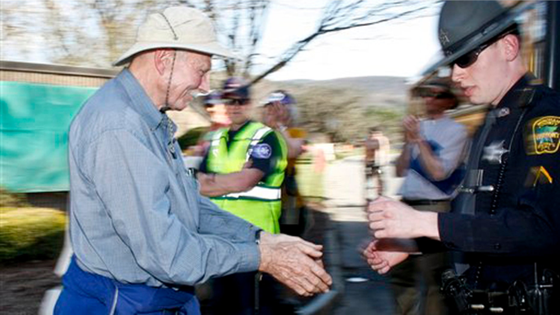 March 22, 2012: A man gets escorted onto a school bus after being arrested for trespassing on Entergy Vermont Yankee property at the Joint Information Center on Old Ferry Road during a large anti Vermont Yankee protest, Thursday.