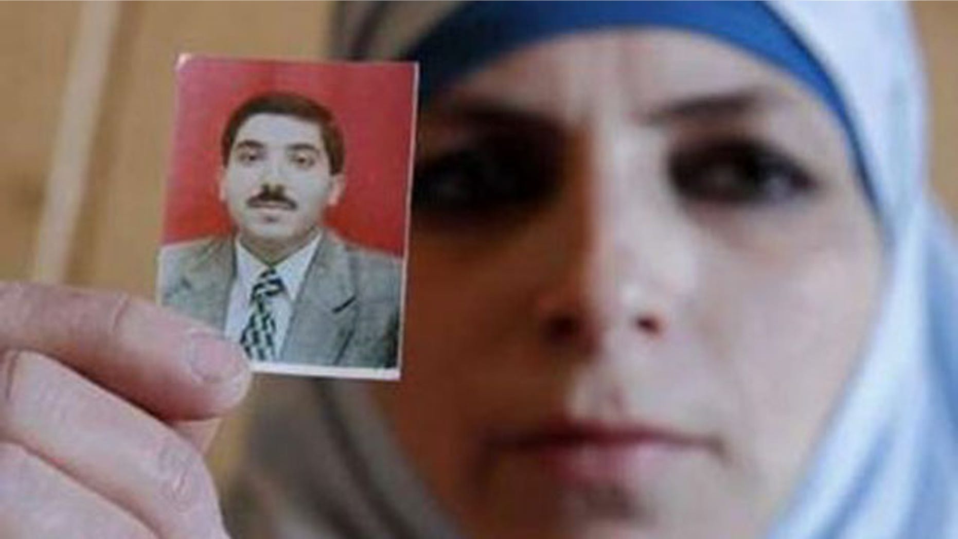 March 11, 2011: Veronica, wife of Dirar Abu Sisi, a Palestinian who disappeared last month in Ukraine, holds up her husband's photo during a meeting with journalists at the Islamic Centre in Kiev.