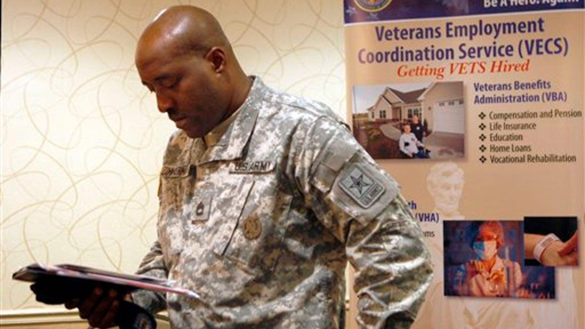 May 3: Army Sgt.1st Class Lonell Zimmerman, of Vineland, N.J., looks over some papers as he attends a job fair aimed at helping military and former military members transition to civilian jobs, in Cherry Hill, N.J.