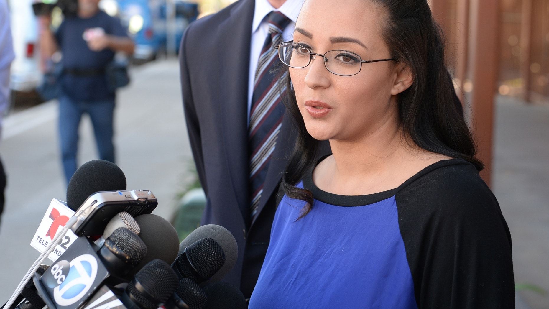 In this Monday, Jan. 20, 2014 photo, a woman who wanted to be identified by her first name, Jamie, speaks at a news conference in front of Alhambra High School in Alhambra, Calif., where Andrea Cardosa last worked as vice principal of student services. Police in Riverside, Calif., are investigating allegations from her and another woman, who say Cardosa, a former middle school teacher and administrator, abused them while they were students in Riverside County. (AP Photo/The Pasadena Star-News, Keith Durflinger) MAGS OUT; NO SALES; MANDATORY CREDIT