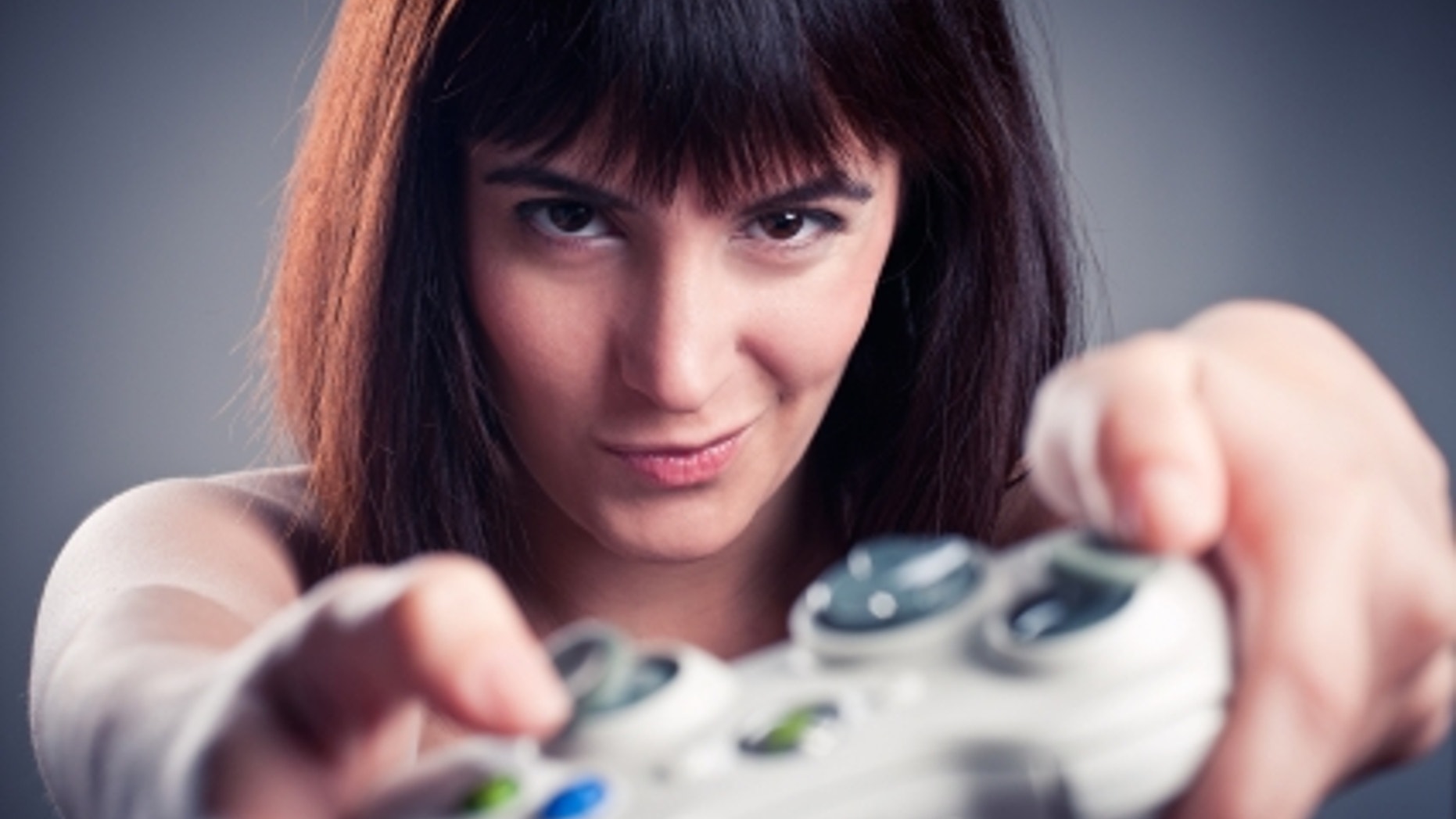 Girl playing videogames in a funny face