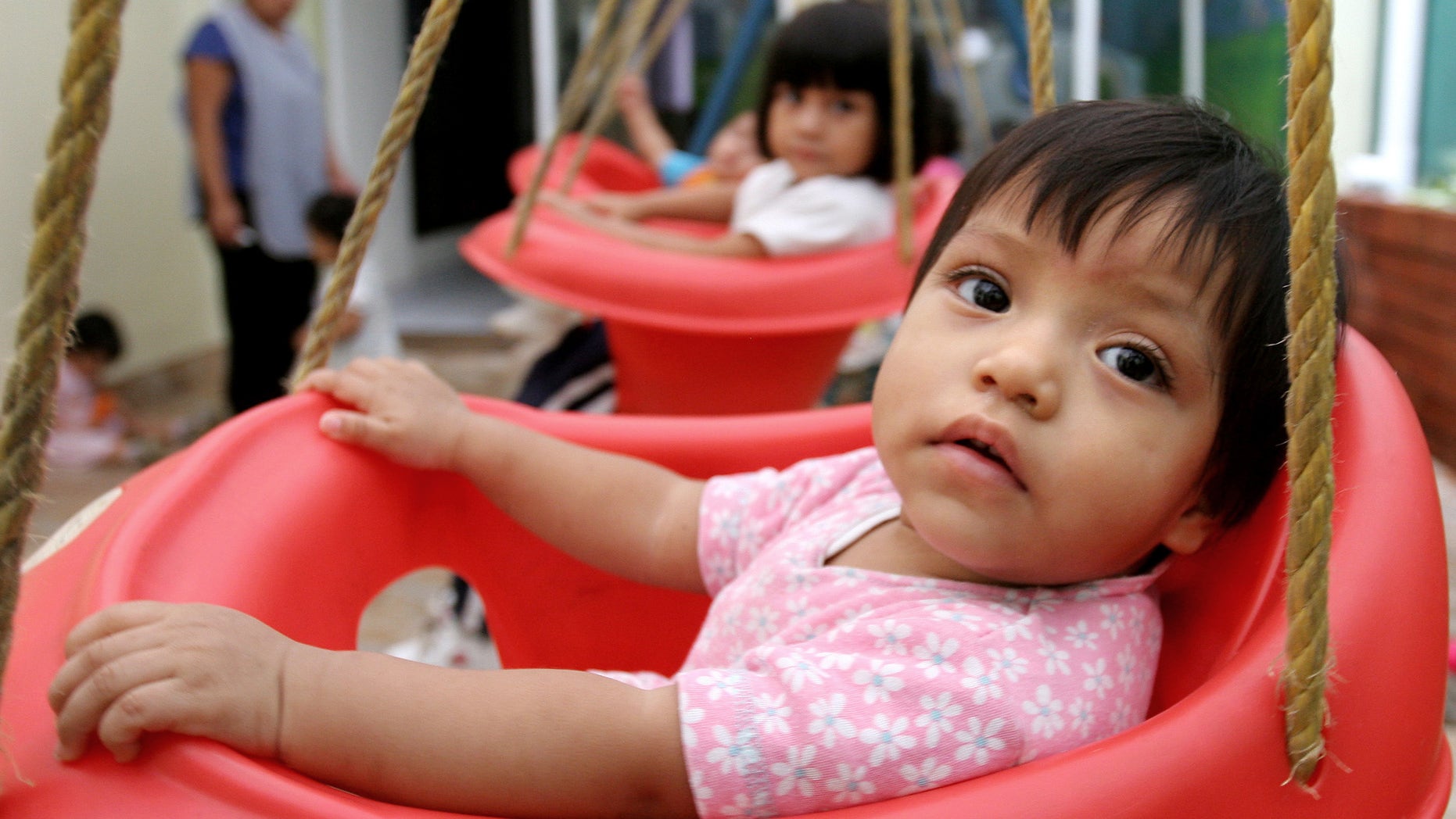 In this June 12, 2006 file photo, children waiting for adoptions are seen in a house held by a lawyer specialized in adoptions in Guatemala City, Guatemala. The number of international adoptions has plummeted to its lowest point in 15 years, a steep decline attributed largely to crackdowns against baby-selling, a sputtering world economy and efforts by countries to place more children with domestic families. (AP Photo/Alexandre Meneghini, File)