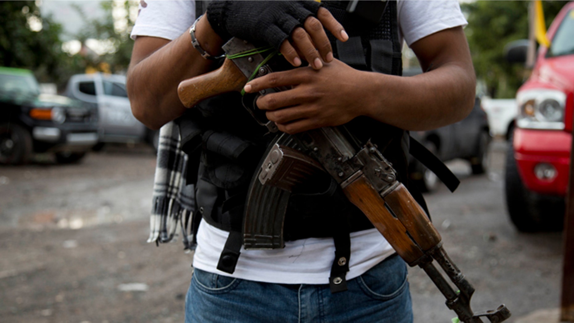 FILE - In this Jan. 16, 2014 file photo, an armed man belonging to the Self-Defense Council of Michoacan, (CAM), stands guard at a checkpoint set up by the self-defense group at the entrance to Antunez, Mexico. Mexico essentially legalized the countryâs growing âself-defenseâ groups Monday, Jan. 27, 2014, while also announcing that security forces had captured one of the four top leaders of the Knights Templar drug cartel, which the vigilante groups have been fighting for the last year. The government said it had reached an agreement with vigilante leaders to incorporate the armed civilian groups into old and largely forgotten quasi-military units called the Rural Defense Corps. (AP Photo/Eduardo Verdugo, File)