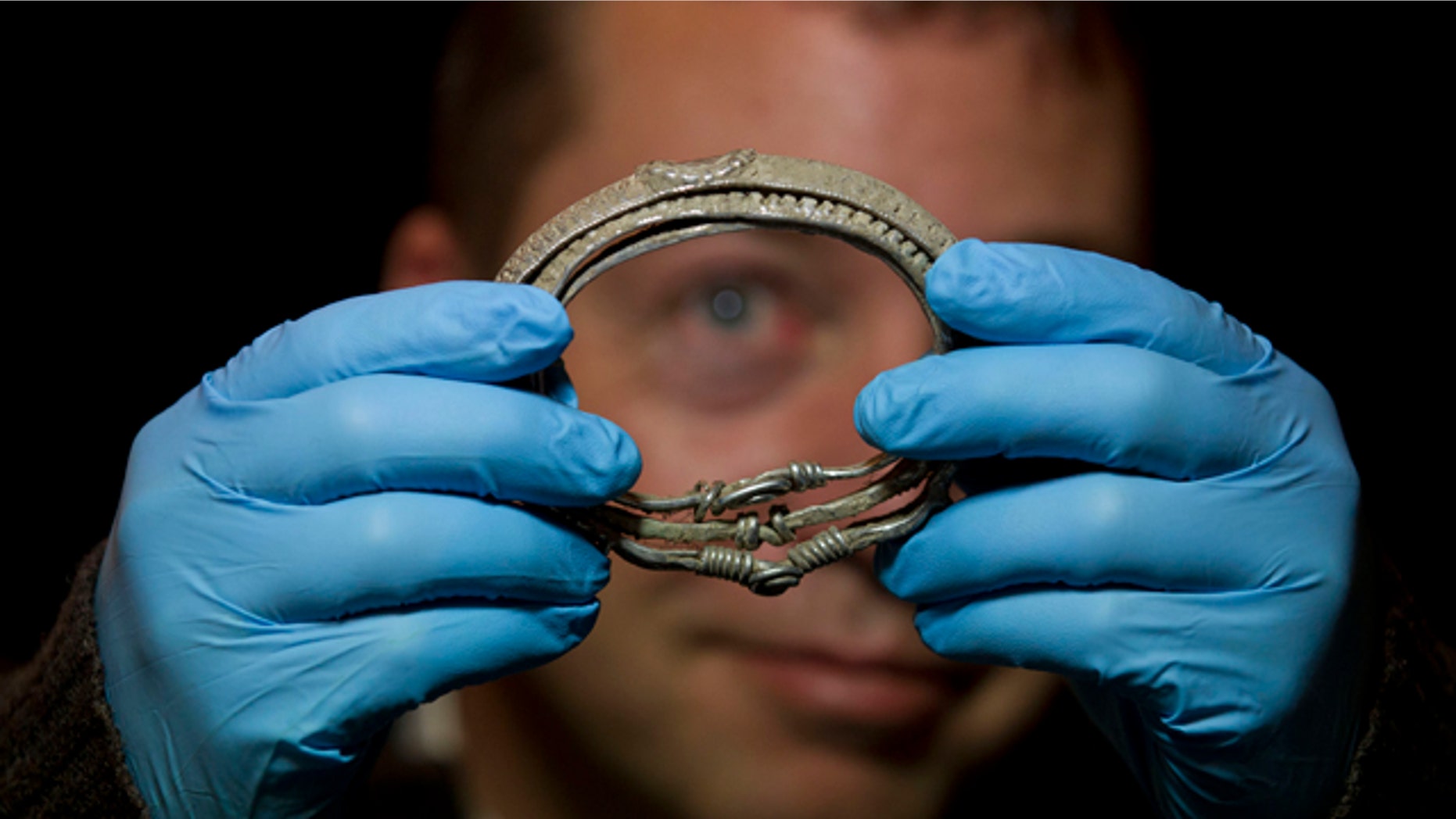 Dec. 14, 2011: Metal detectorist Darren Webster poses with a Viking arm-ring he discovered, estimated to date back to the late ninth or early tenth century, at the British Museum in London. The arm-ring is part of the Silverdale Viking Hoard discovered by Webster in September 2011 in the Silverdale area of North Lancashire, England. It comprises 201 silver objects including arm-rings, coins, finger-rings, ingots, brooch fragments and a fine wire braid.