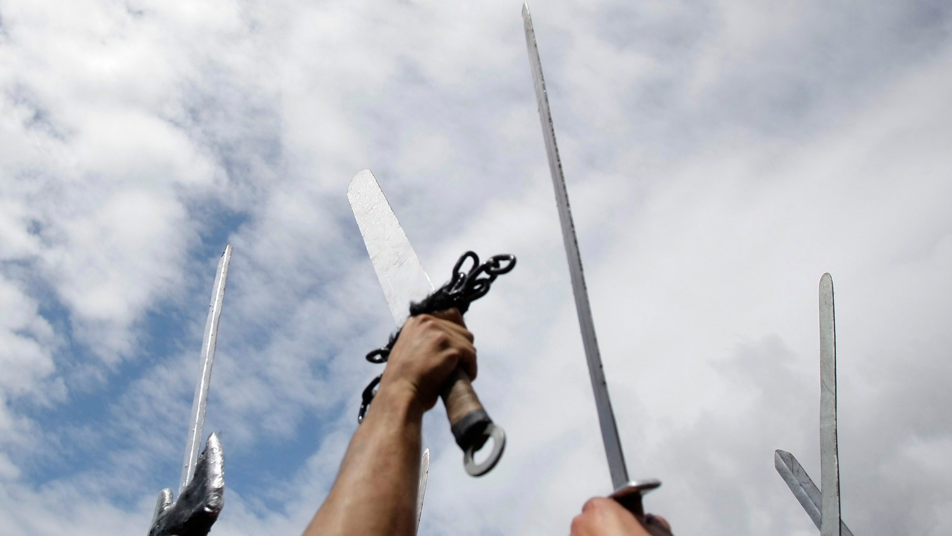 File photo - Participants dressed up as Vikings raise their swords as they take part in the annual Viking festival of Catoira in north-western Spain Aug. 7, 2011.