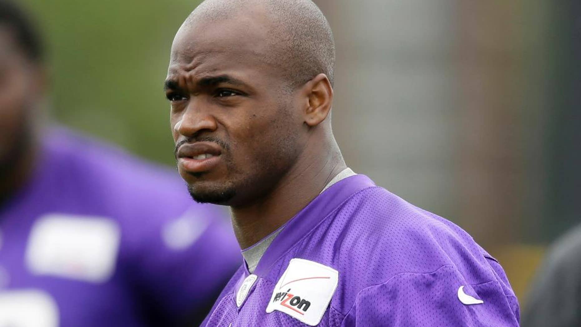 FILE - In this July 28, 2014, file photo, Minnesota Vikings running back Adrian Peterson looks on during NFL football training camp in Mankato, Minn. Peterson acknowledges he struck his young son with a branch, but insists he did not commit a crime. That belief is to draw further attention this week when the case against the Vikings' star running back goes before a Texas judge. (AP Photo/Charlie Neibergall, File)
