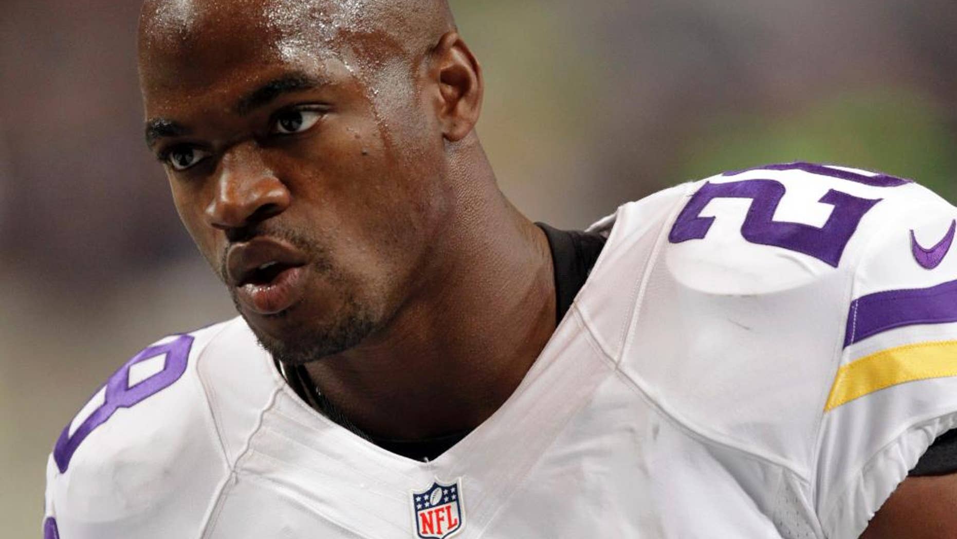 FILE - In this Sept. 7, 2014, file photo, Minnesota Vikings running back Adrian Peterson warms up for an NFL football game against the St. Louis Rams in St. Louis. The Vikings benched Peterson for Sunday's game after his attorney said he had been indicted by a Texas grand jury on a charge of child abuse. Attorney Rusty Hardin says the charge accuses Peterson of using a branch, or switch, to spank his son. He says Peterson has cooperated with authorities and "used his judgment as a parent to discipline his son." Hardin says Peterson regrets the incident but never intended to harm the boy. (AP Photo/Tom Gannam, File)