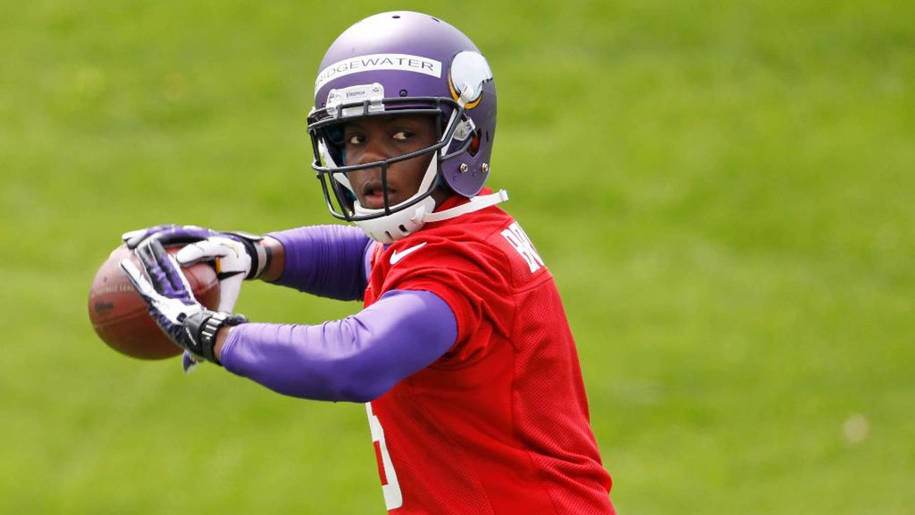 Quarterback Teddy Bridgewater drops back to pass during Minnesota Vikings minicamp in Eden Prairie, Minn., Friday, May 16, 2014. New Vikings coach Mike Zimmer set to work getting young players like Bridgewater, linebacker Anthony Barr and defensive backs Antone Exum and Kendall James up to speed on what will be expected of them in the NFL. (AP Photo/Ann Heisenfelt)