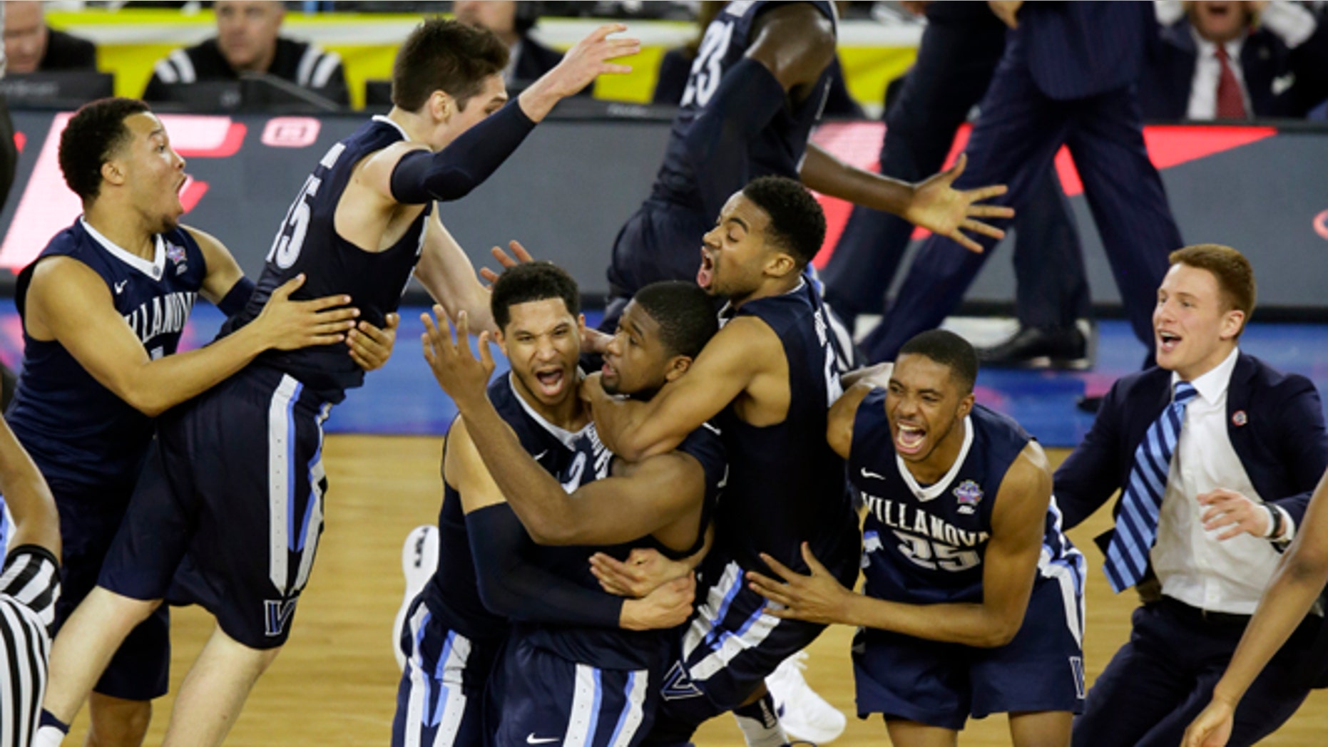 Villanova players celebrates after Kris Jenkins, center, scores a game winning three point basket in the closing seconds of NCAA Final Four tournament college basketball championship game Monday, April 4, 2016, in Houston. Villanova won 77-74. (AP Photo/Charlie Neibergall)