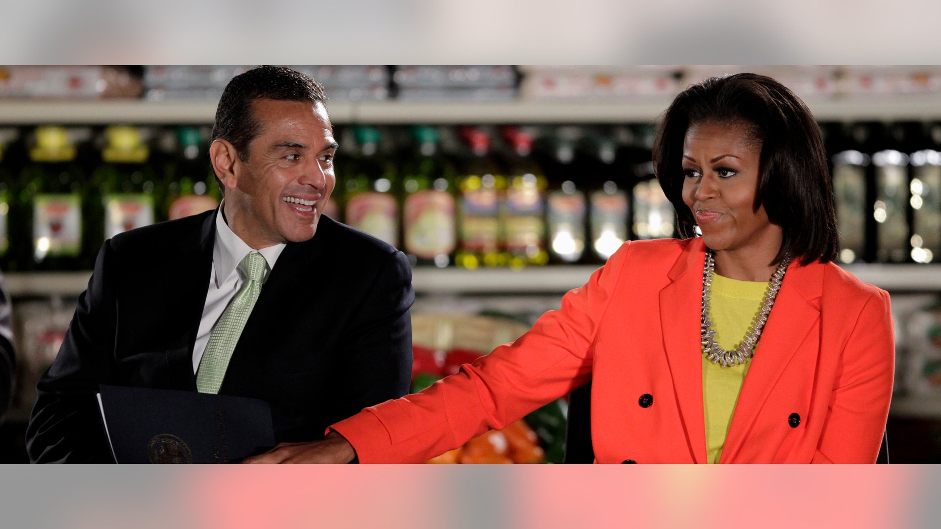 Mayor Antonio Villaraigosa is joined by First lady Michelle Obama in Inglewood, Calif., Wednesday, Feb. 1, 2012. (AP Photo/Jae C. Hong)