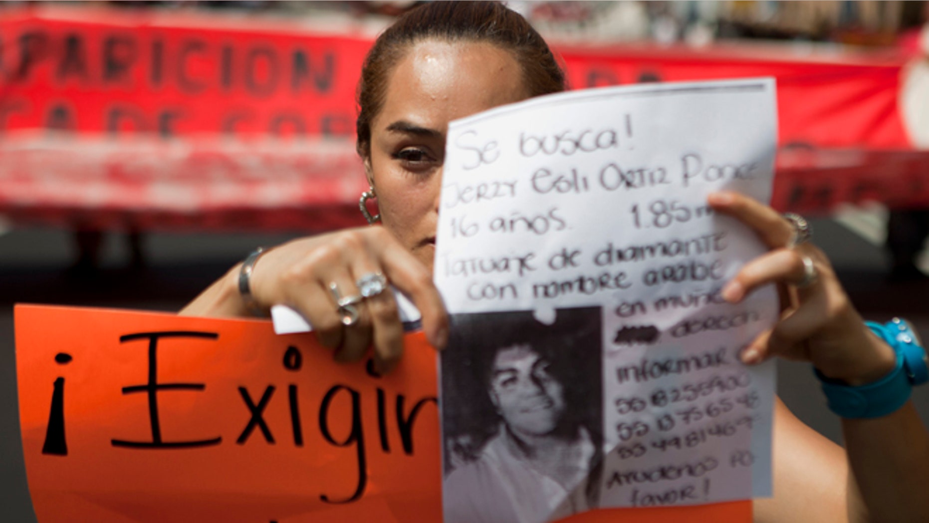 May 30: A woman holds up a sign with details of her recently disappeared relative during a protest in Mexico City.