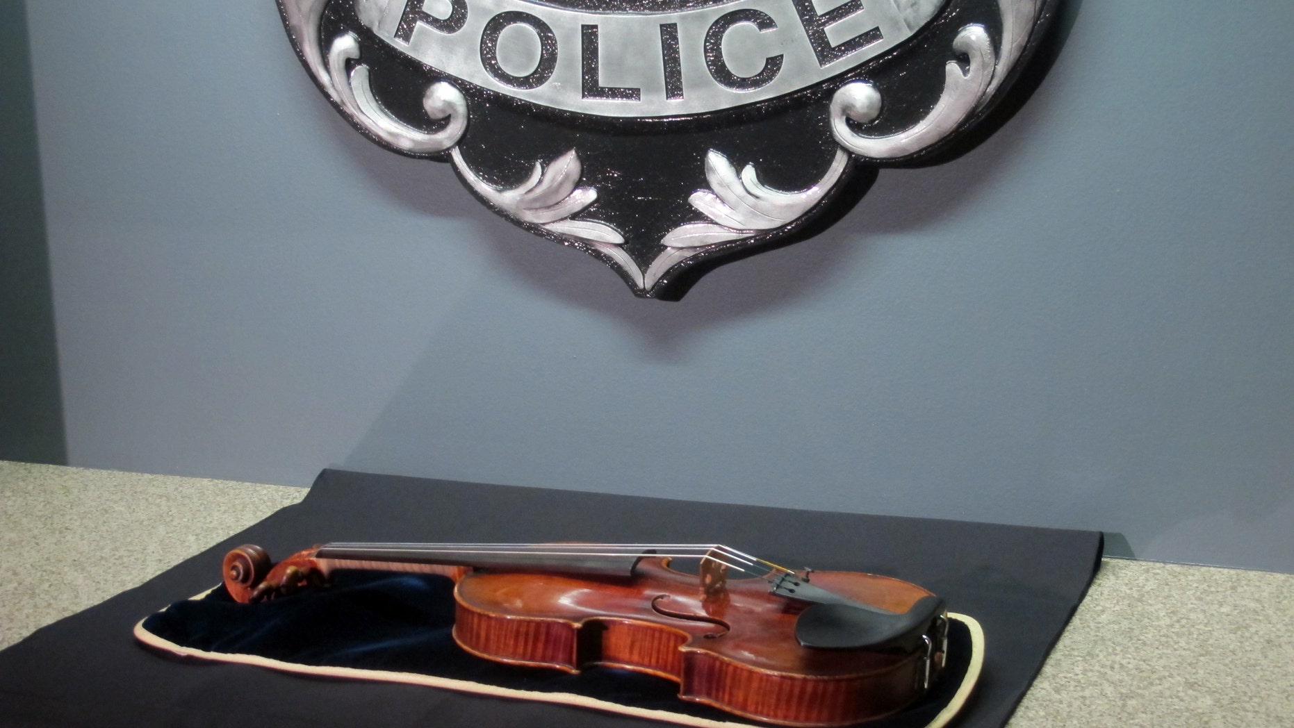 Feb. 6, 2014 - A $5 million Stradivarius violin is displayed at the Milwaukee Police Department in Milwaukee, a day after police recovered the instrument stolen on Jan. 27 from a concertmaster in a parking lot by a person wielding a stun gun. Police say the violin appears to be in good condition.