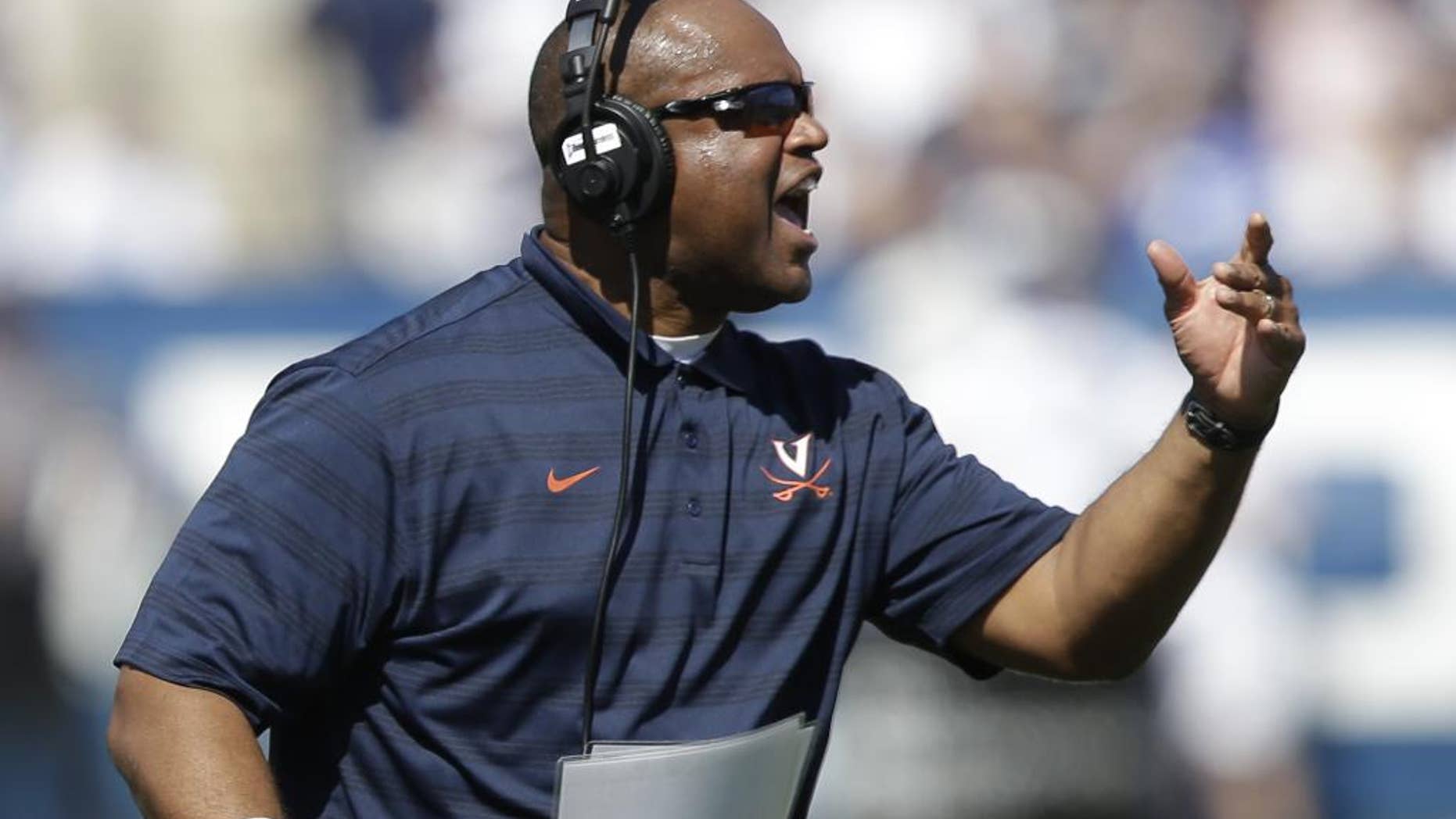 Virginia head coach Mike London reacts to a call in the second quarter during an NCAA college football game against Brigham Young, Saturday, Sept. 20, 2014, in Provo, Utah. (AP Photo/Rick Bowmer)