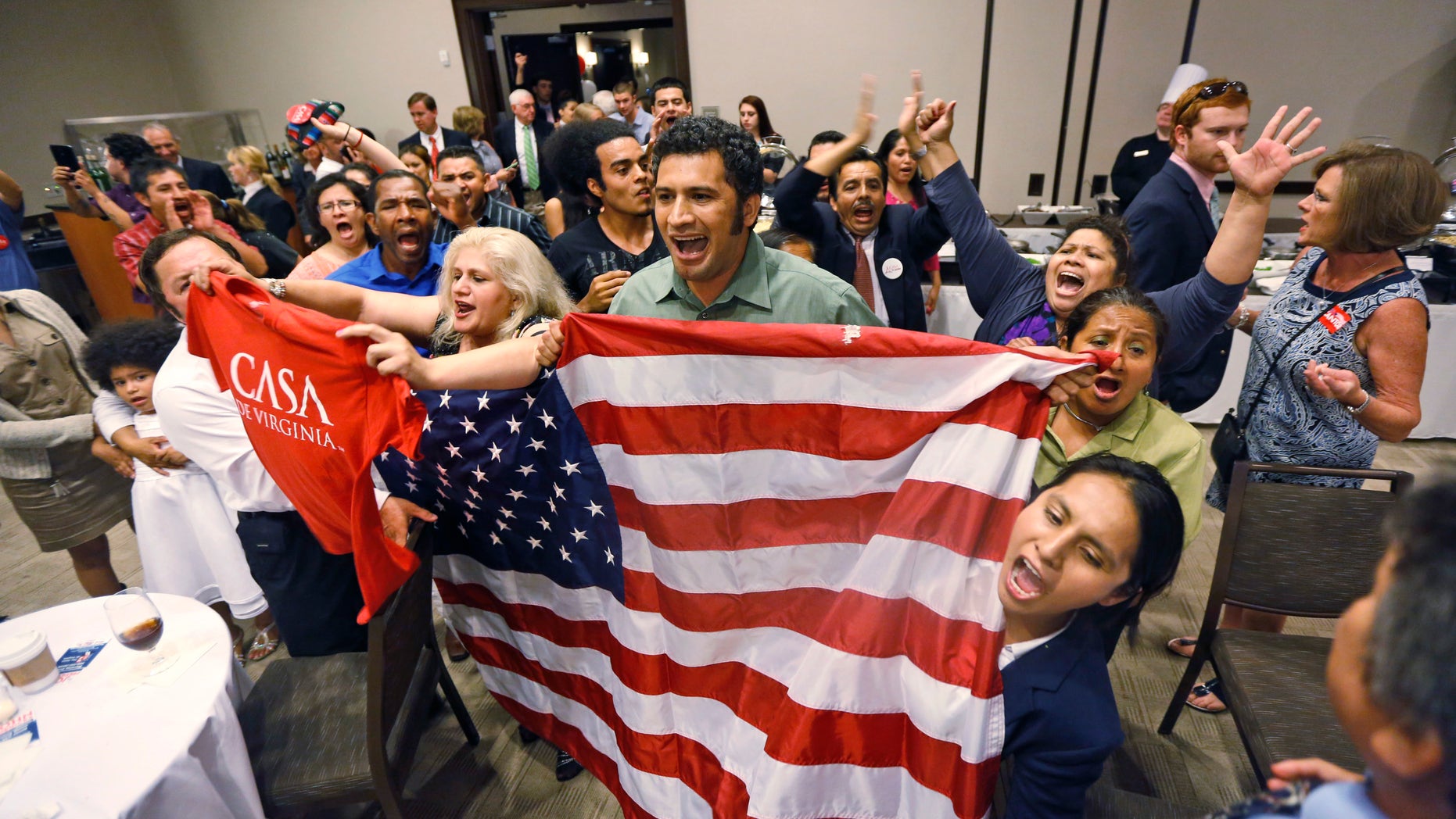 Immigration reform supporters crash the primary-night party of House Majority Leader Eric Cantor, R-Va., after he delivered a concession speech in Richmond, Va., Tuesday, June 10, 2014. Cantor lost in the GOP primary to tea party candidate Dave Brat. (AP Photo/Steve Helber)