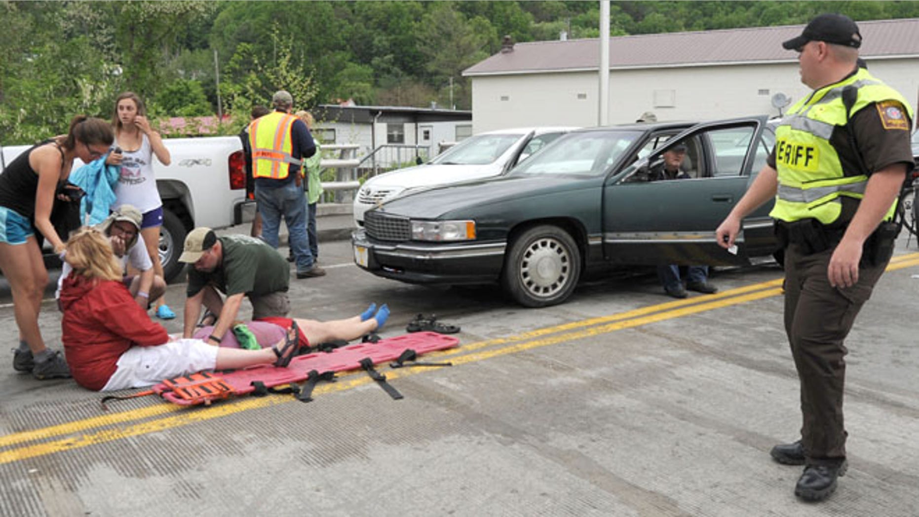 May 18, 2013: Emergency personnel respond to one of the people hit by a car, at right, during the beginning of the Hikers Parade at the Trail Days festival in Damascus, Va.