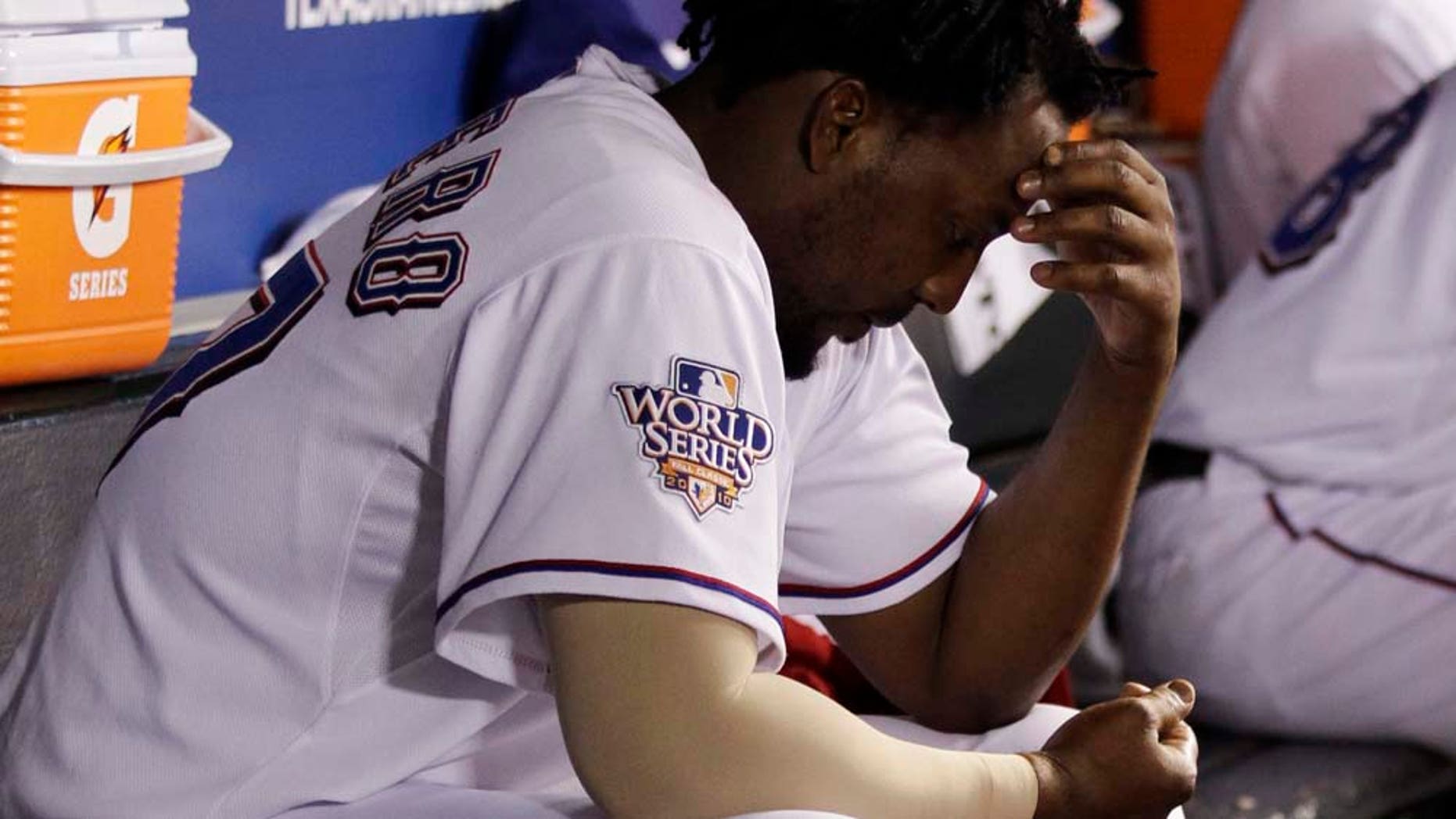 Texas Rangers' Vladimir Guerrero sits in the dugout after striking out during the seventh inning of Game 4 of baseball's World Series against the San Francisco Giants Sunday, Oct. 31, 2010, in Arlington, Texas. (AP Photo/David J. Phillip)