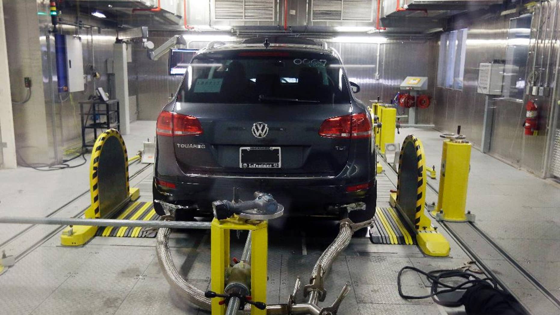 FILE - In this Oct. 13, 2015 file photo, a Volkswagen Touareg diesel is tested in the Environmental Protection Agency's cold temperature test facility in Ann Arbor, Mich. The U.S. government says Volkswagen cheated a second time on emissions tests, programming about 10,000 cars with larger diesel engines, including the 2014 Touareg, 2015 Porsche Cayenne and the 2016 Audi A6 Quattro, A7 Quattro, A8 and Q5, to emit fewer pollutants during testing than in real-world driving conditions. (AP Photo/Carlos Osorio, File)