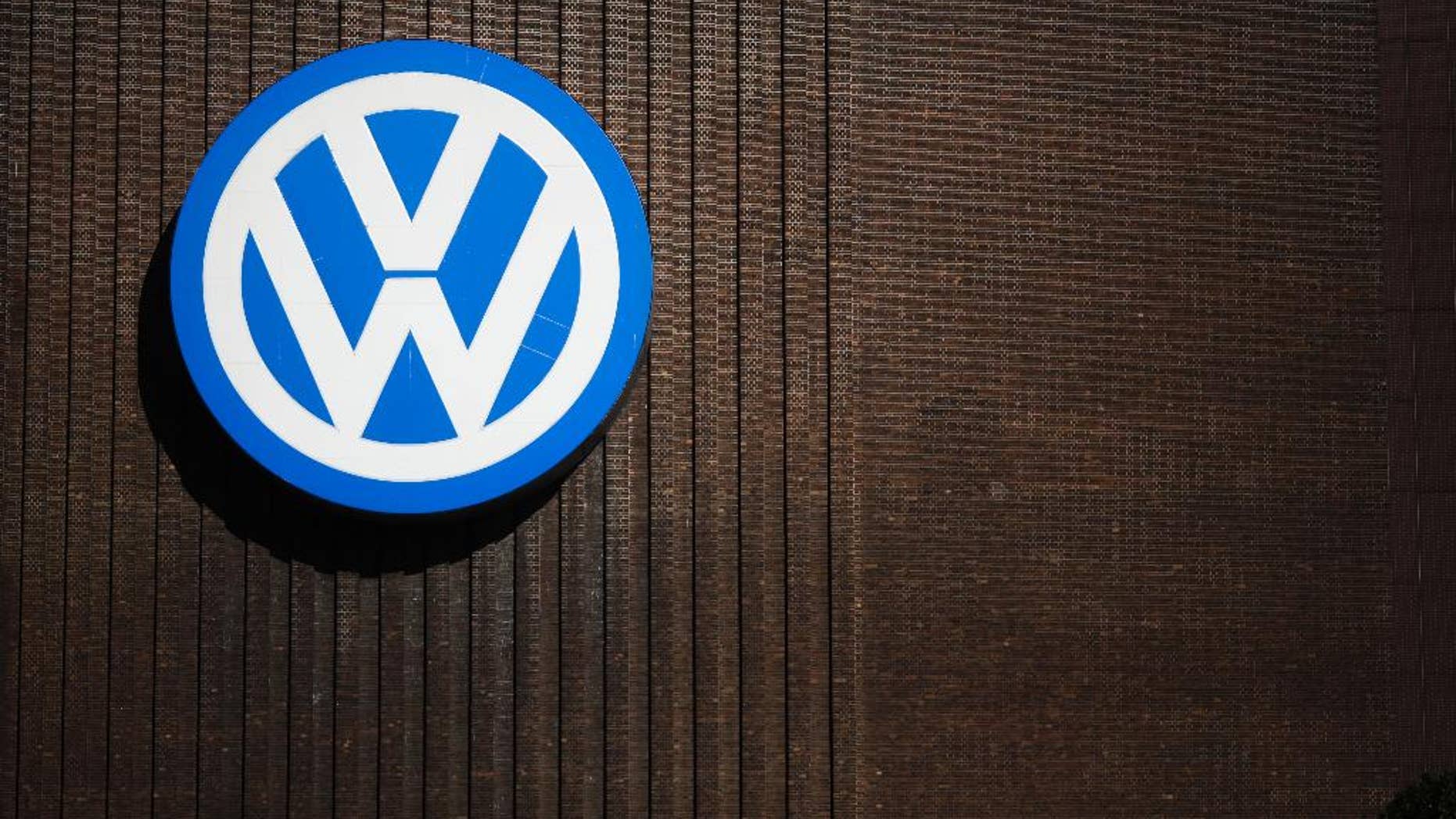 FILE - In this Sept. 29, 2015, file photo, a brand sign of the Volkswagen car company is seen at the car factory in Wolfsburg, Germany. More than a decade ago, the U.S. Environmental Protection Agency helped develop a technology that ultimately allowed an independent laboratory to catch Volkswagen’s elaborate cheating on car emissions tests. But EPA did not apply that technology on its own tests of diesel passenger cars and instead focused on trucks,thus missing its best chance to foil the German carmaker’s deception as early as 2007. (AP Photo/Markus Schreiber, File)